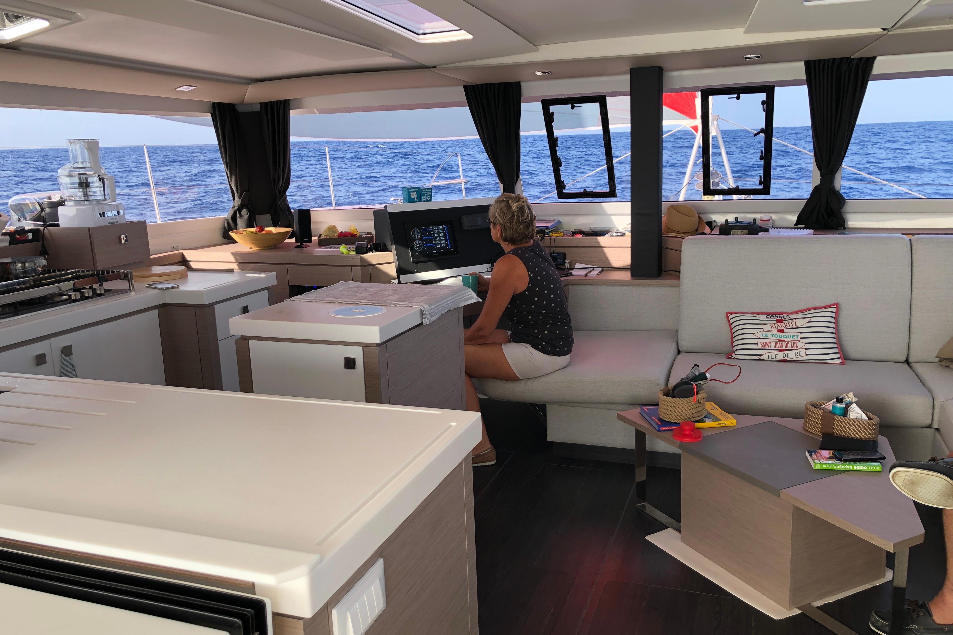 Interior of 2020 Fountaine Pajot Saona 47 catamaran with modern kitchen and seating area.