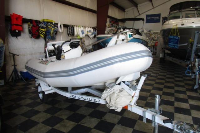 2000 Zodiac Yachtline 340DL inflatable boat on trailer in showroom.