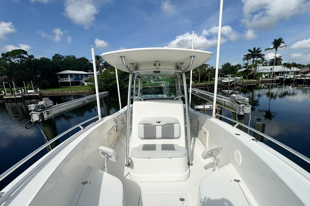 2018 Mako 284 Center Console boat docked in a serene marina setting.