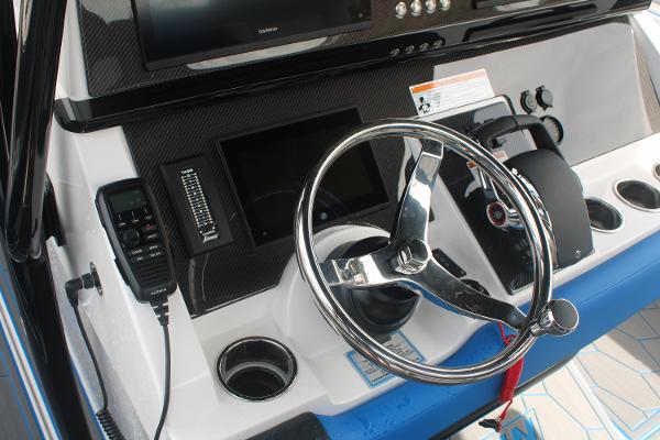 2024 Fountain 34 SC boat dashboard with steering wheel and control panel.