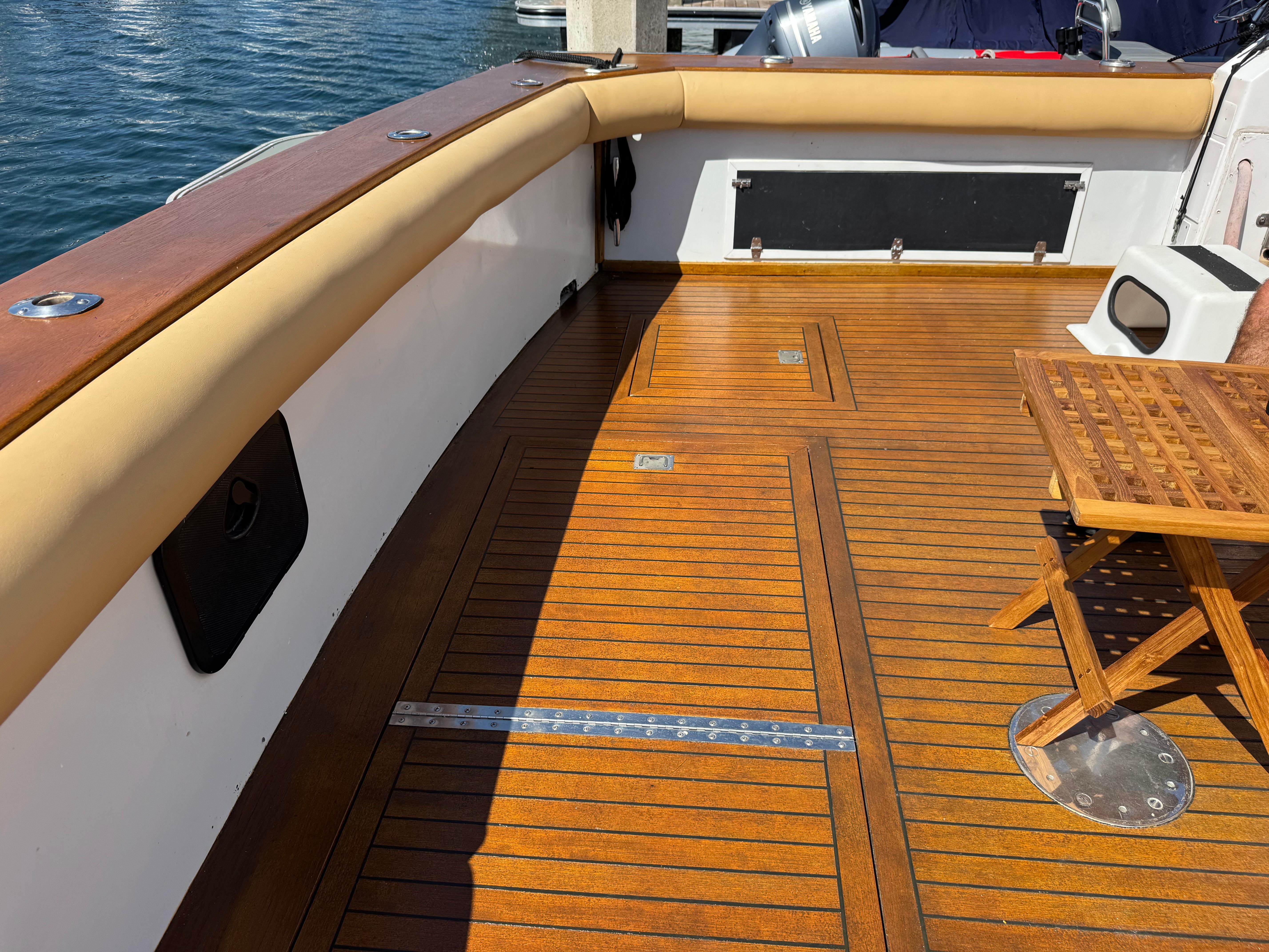1981 Bertram 58 Flybridge Motor Yacht deck with wooden flooring and seating area.
