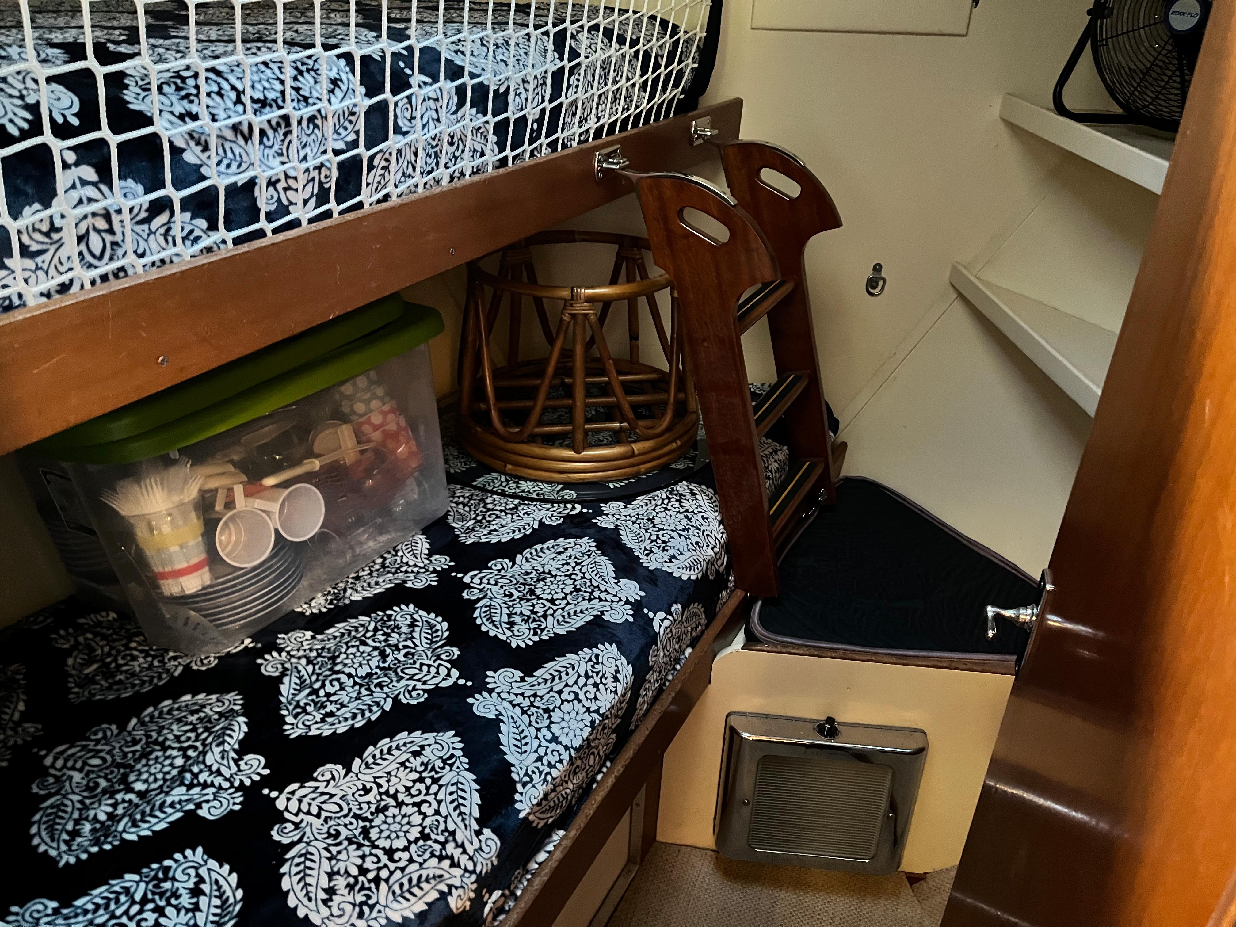 1962 Chris-Craft Constellation cabin interior with bunk beds and storage.
