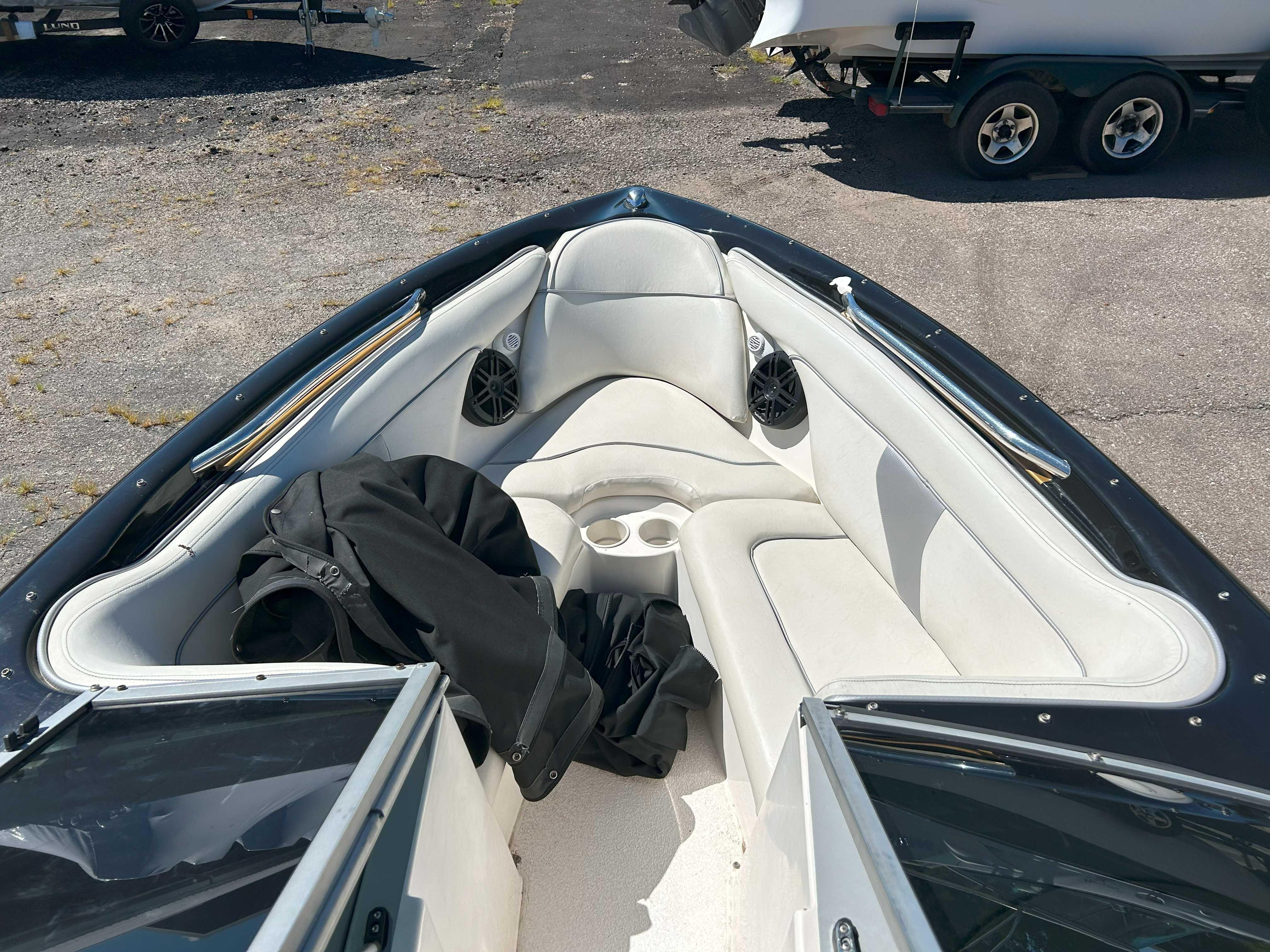 2002 MasterCraft XStar boat interior with white seating and speakers.