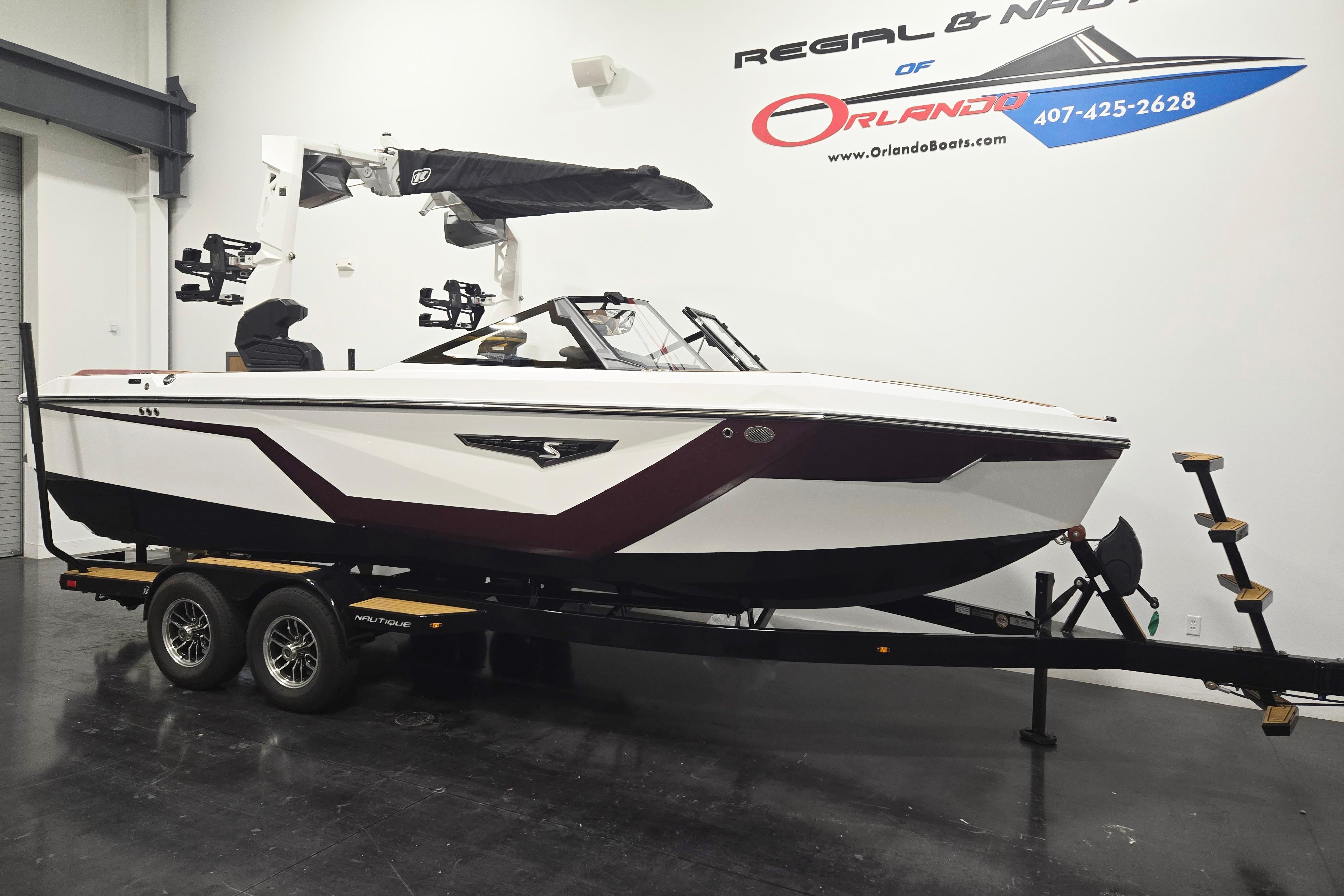 2026 Nautique Super Air Nautique S23 boat on trailer in showroom.