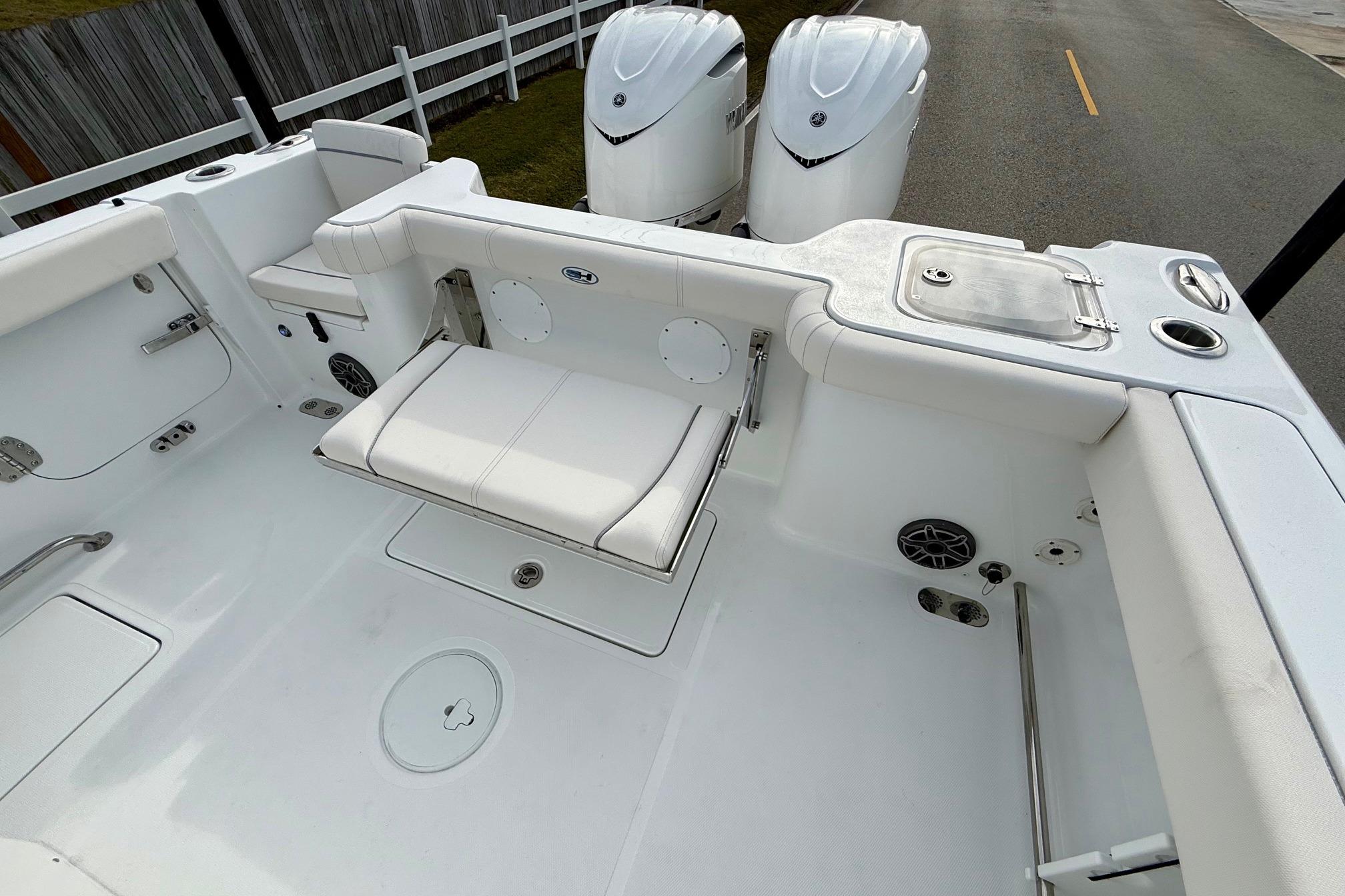 2026 Sea Hunt Gamefish 30 Coffin Box boat interior with seating and dual engines.