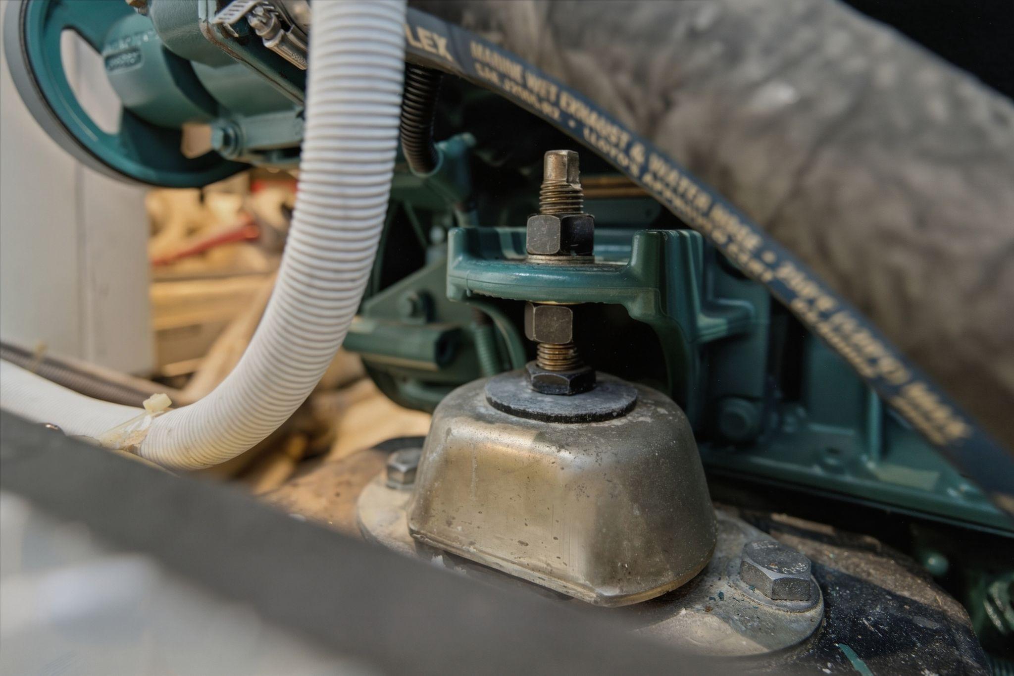 Close-up of a 2005 Carver 39 Motor Yacht engine component with hoses and bolts.