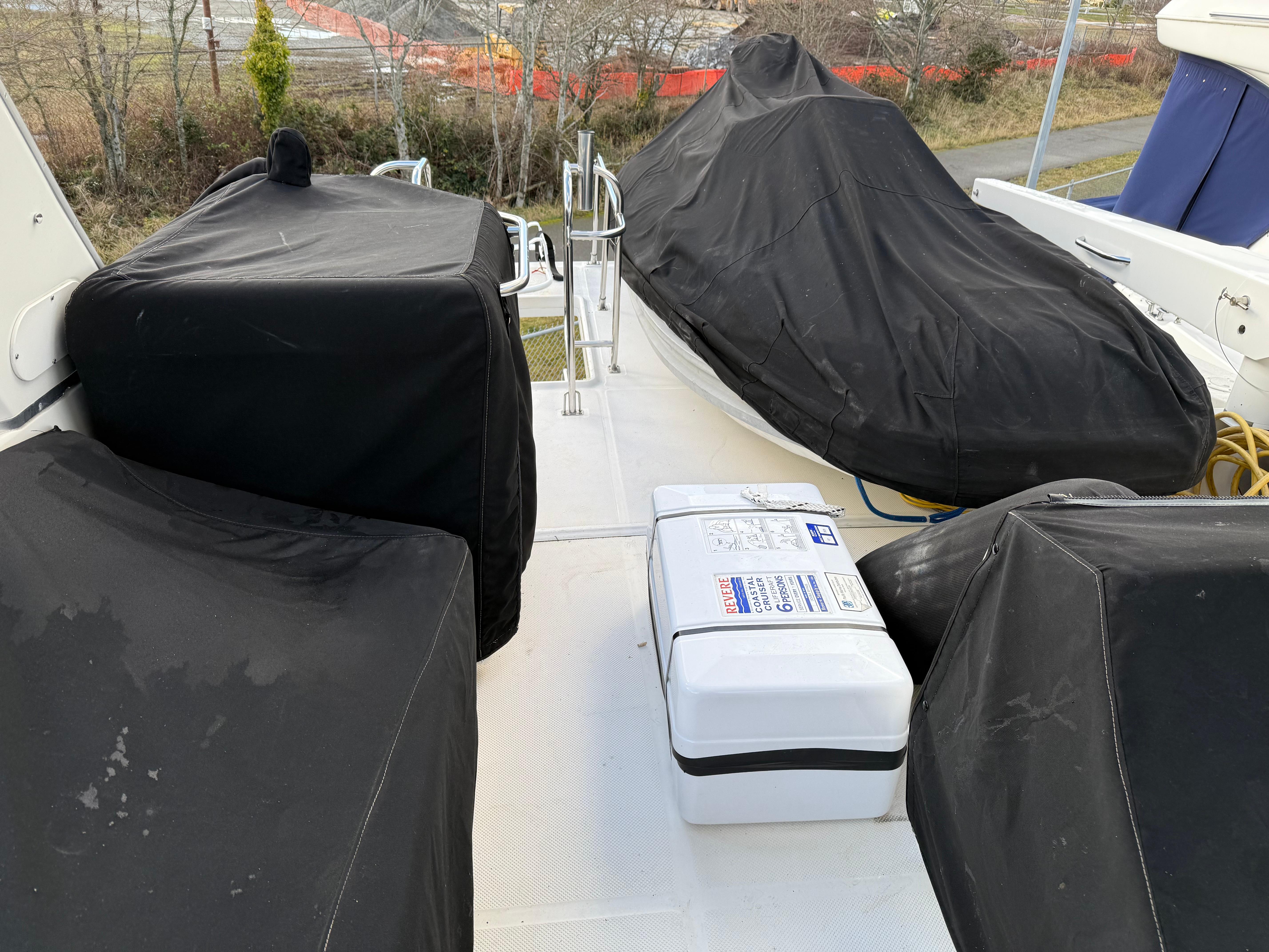 2003 Meridian 490 Pilothouse deck with covered equipment and storage box.