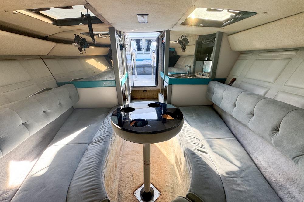 Interior of a 1989 Formula 292 SR-1 boat with plush seating and a central table.