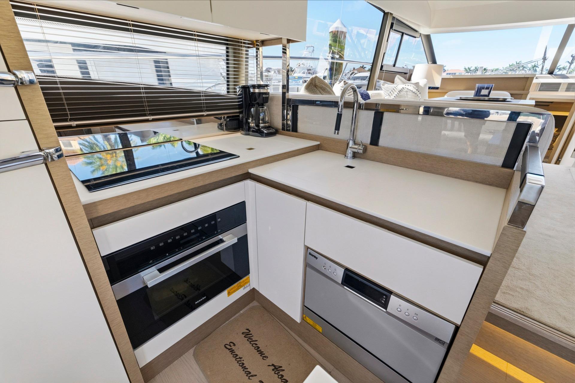 Modern kitchen in 2022 Prestige 520 yacht with sleek appliances and stylish design.
