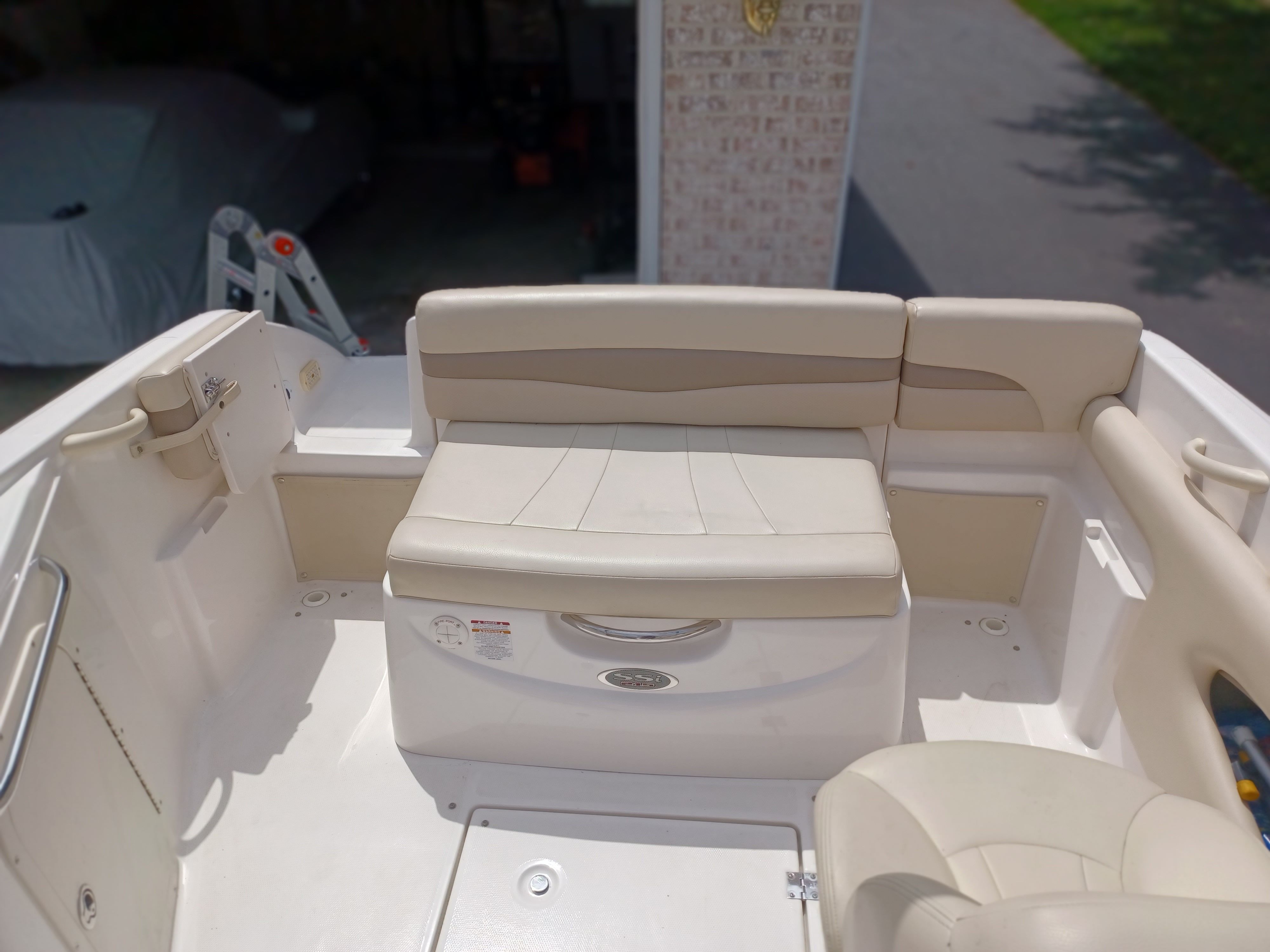The image shows the seating area of a 2004 Chaparral 215 SSi boat with beige upholstery.