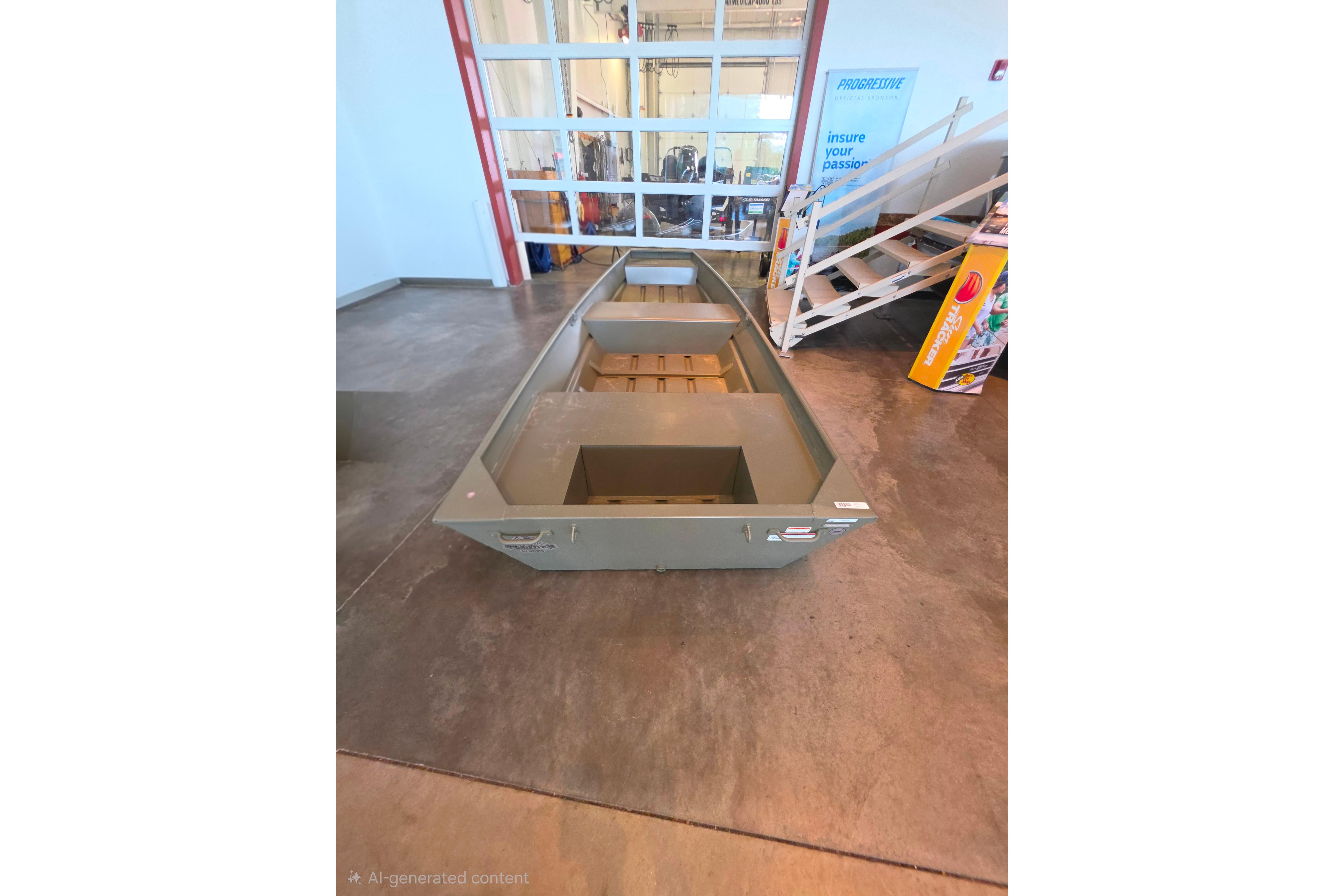 2026 Tracker Grizzly 14 Jon boat displayed indoors on concrete floor.