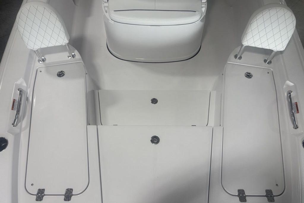 Interior of 2026 Sportsman Masters 227 boat, featuring white seating and storage compartments.