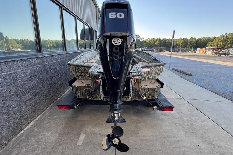 2026 Tracker Grizzly 1756 T Marsh boat with Mercury 60 engine, parked outdoors.