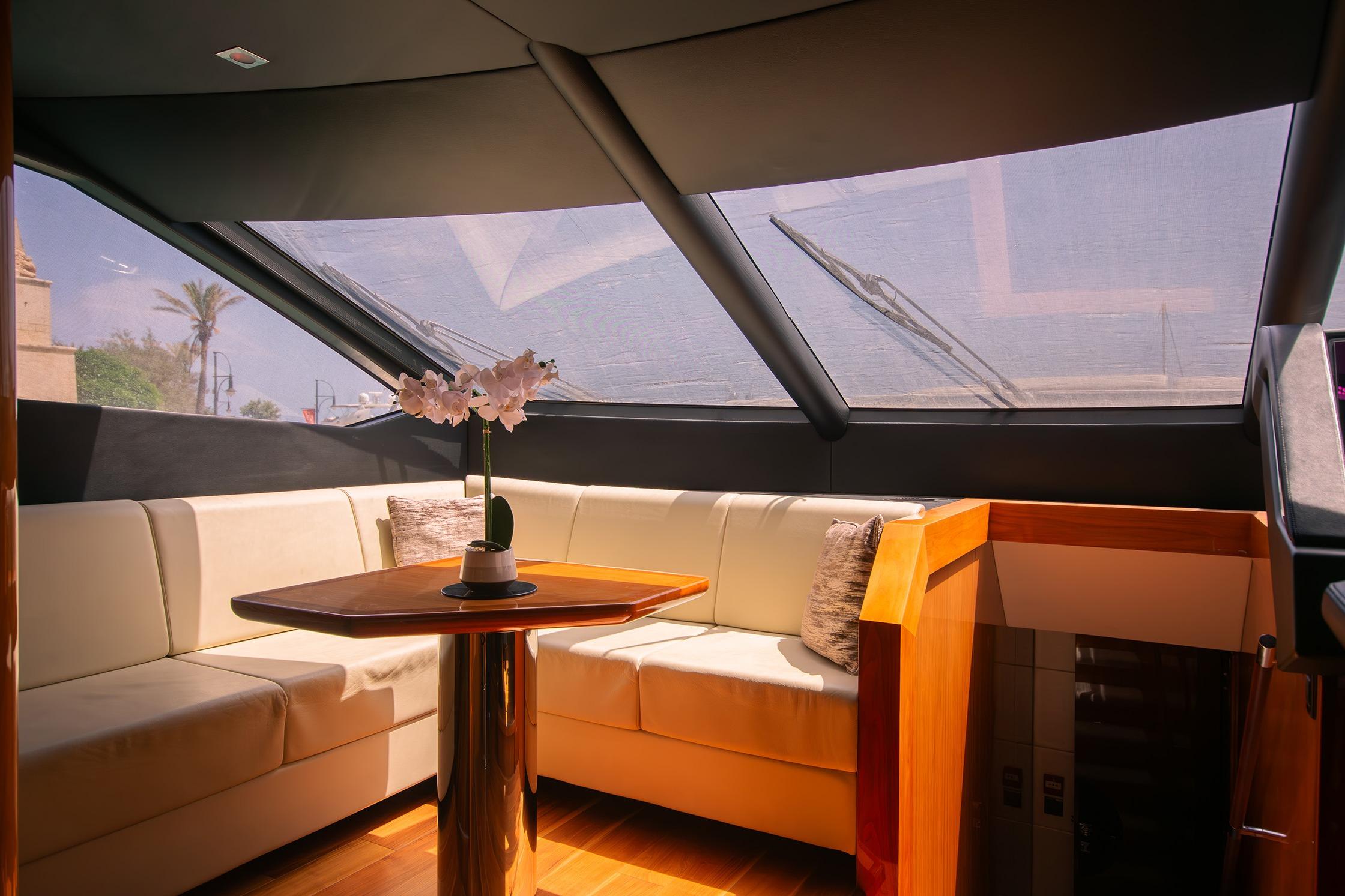Luxurious interior of 2016 Sunseeker 86 Yacht with elegant seating and table.