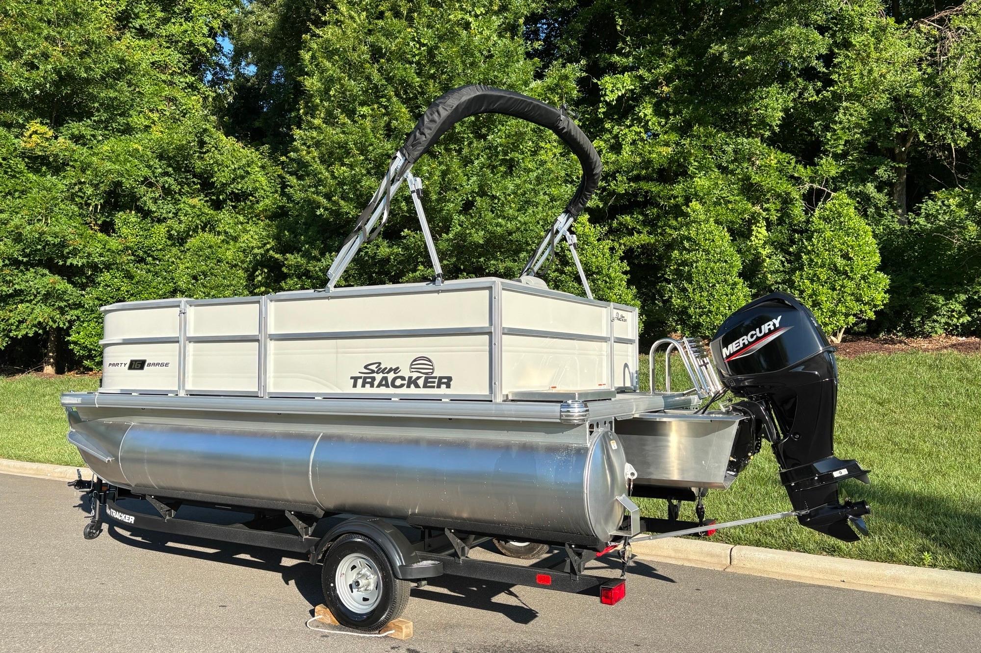 2026 Sun Tracker Party Barge 16 DLX pontoon boat with Mercury outboard motor.