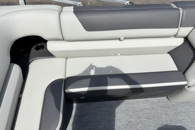 2026 Sun Tracker Fishin' Barge 22 DLX interior seating with gray and white upholstery.