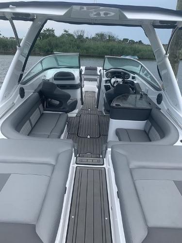 2020 Rinker 29QX BR boat interior with gray seating and modern dashboard.