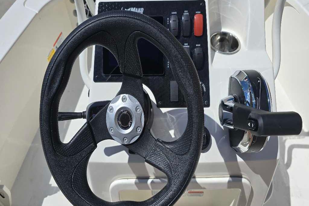 Steering console of 2026 Mako 18 Pro Skiff boat with control panel.