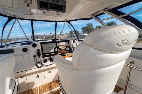 2006 Sea Ray 580 Sedan Bridge helm with luxurious white seating and advanced navigation controls.