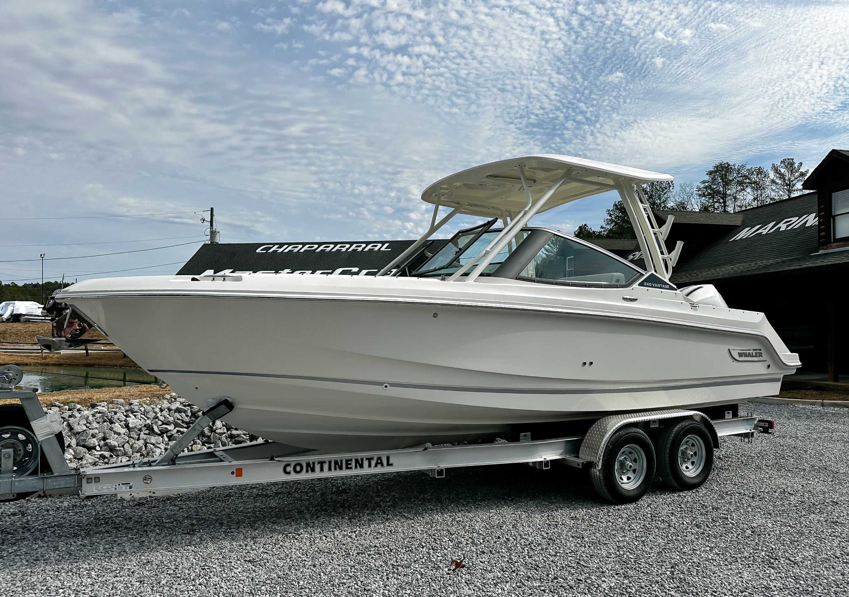 2025 Boston Whaler 240 Vantage on trailer, side view.