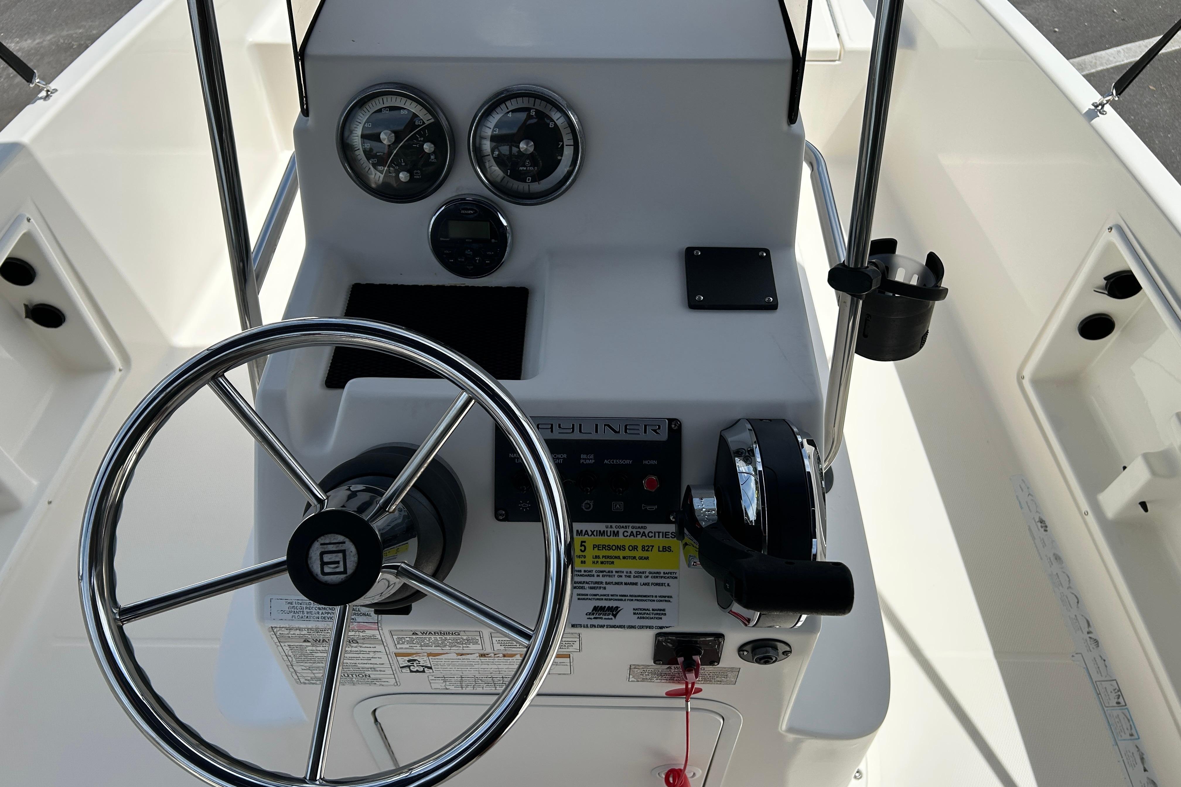 2018 Bayliner Element F16 boat dashboard with steering wheel and control panel.