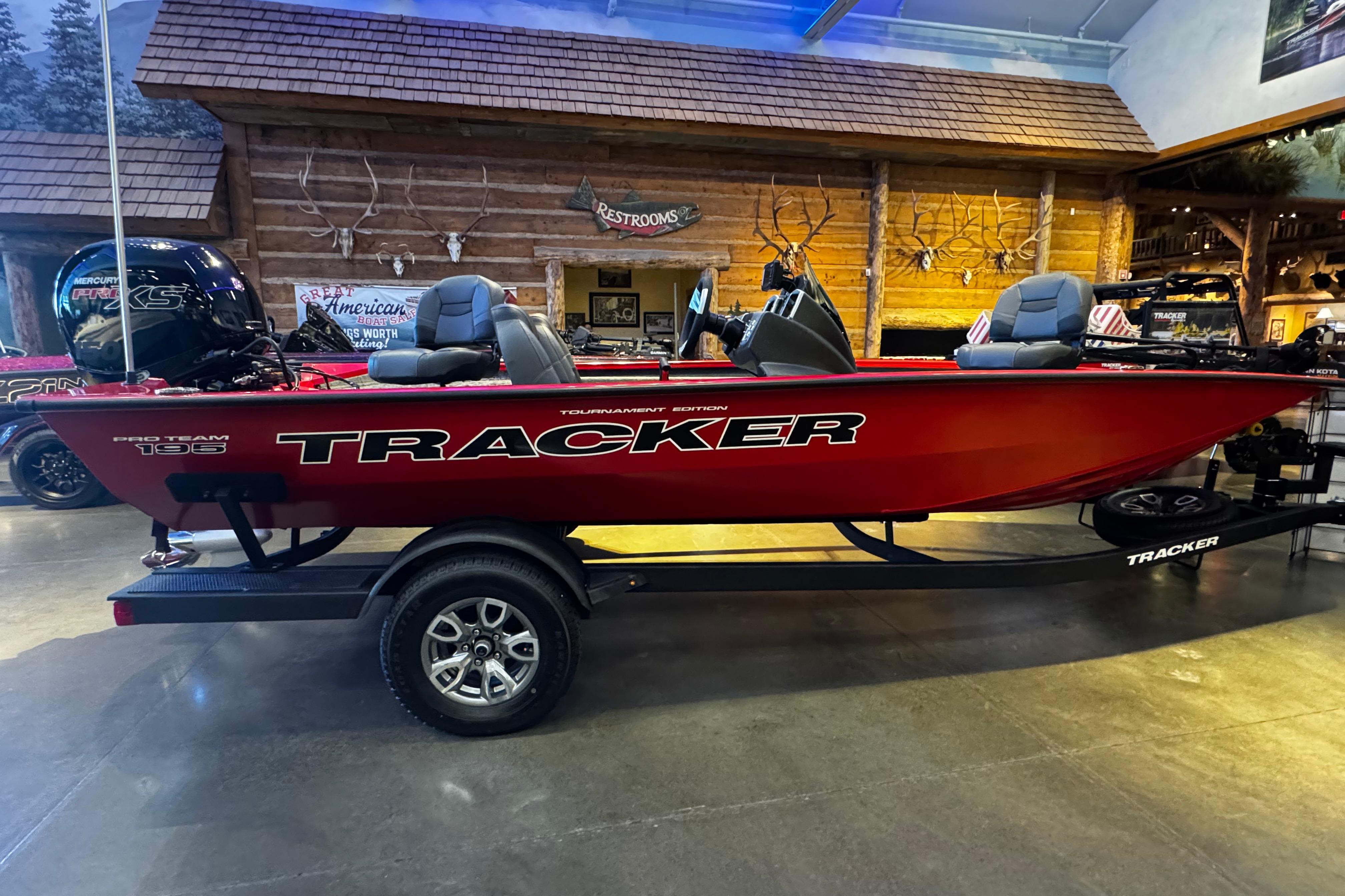 2026 Tracker Pro Team 195 boat displayed indoors with rustic decor.