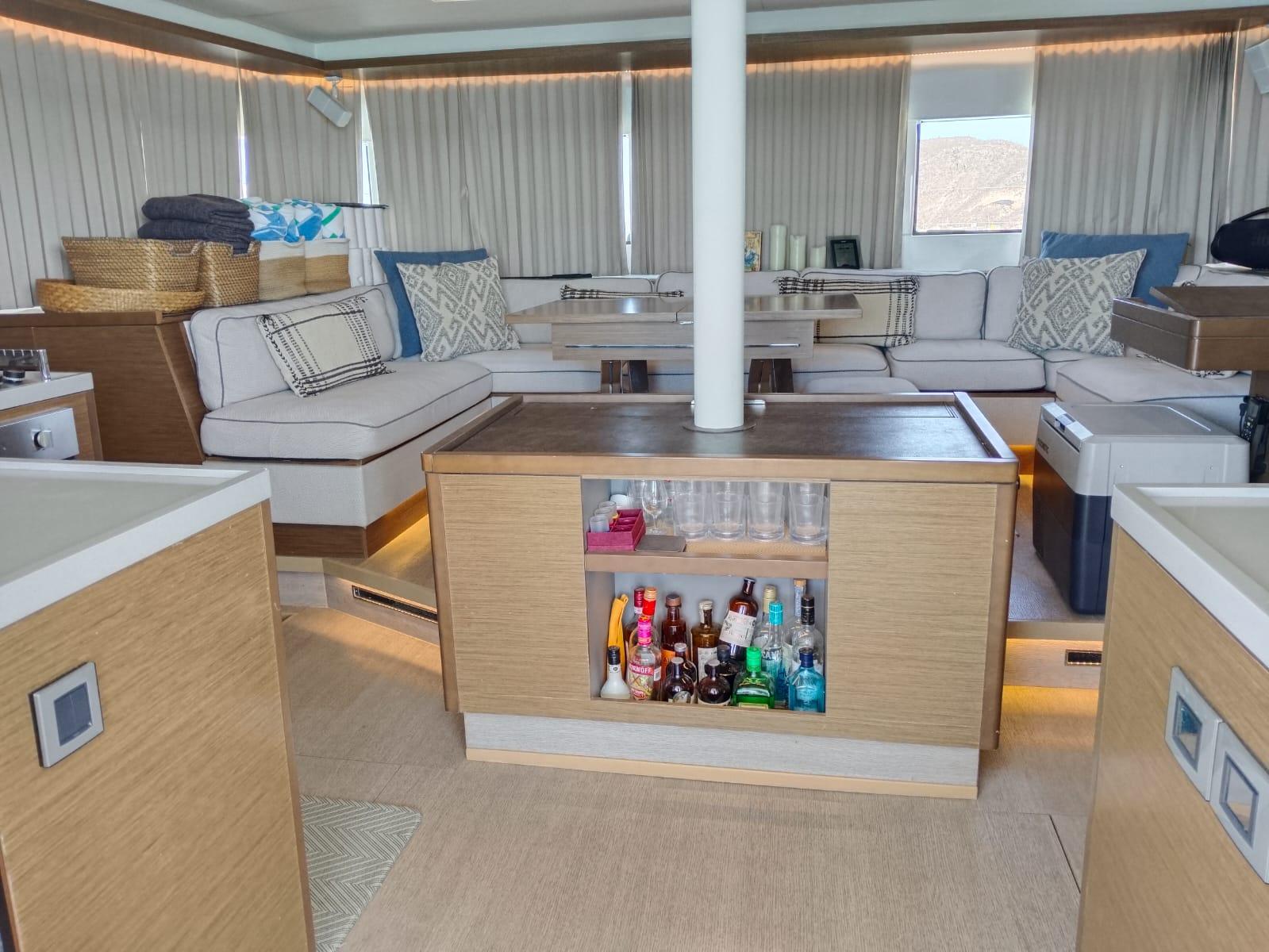 Luxurious interior of a 2018 Lagoon 50 yacht with modern furnishings and a stocked bar.