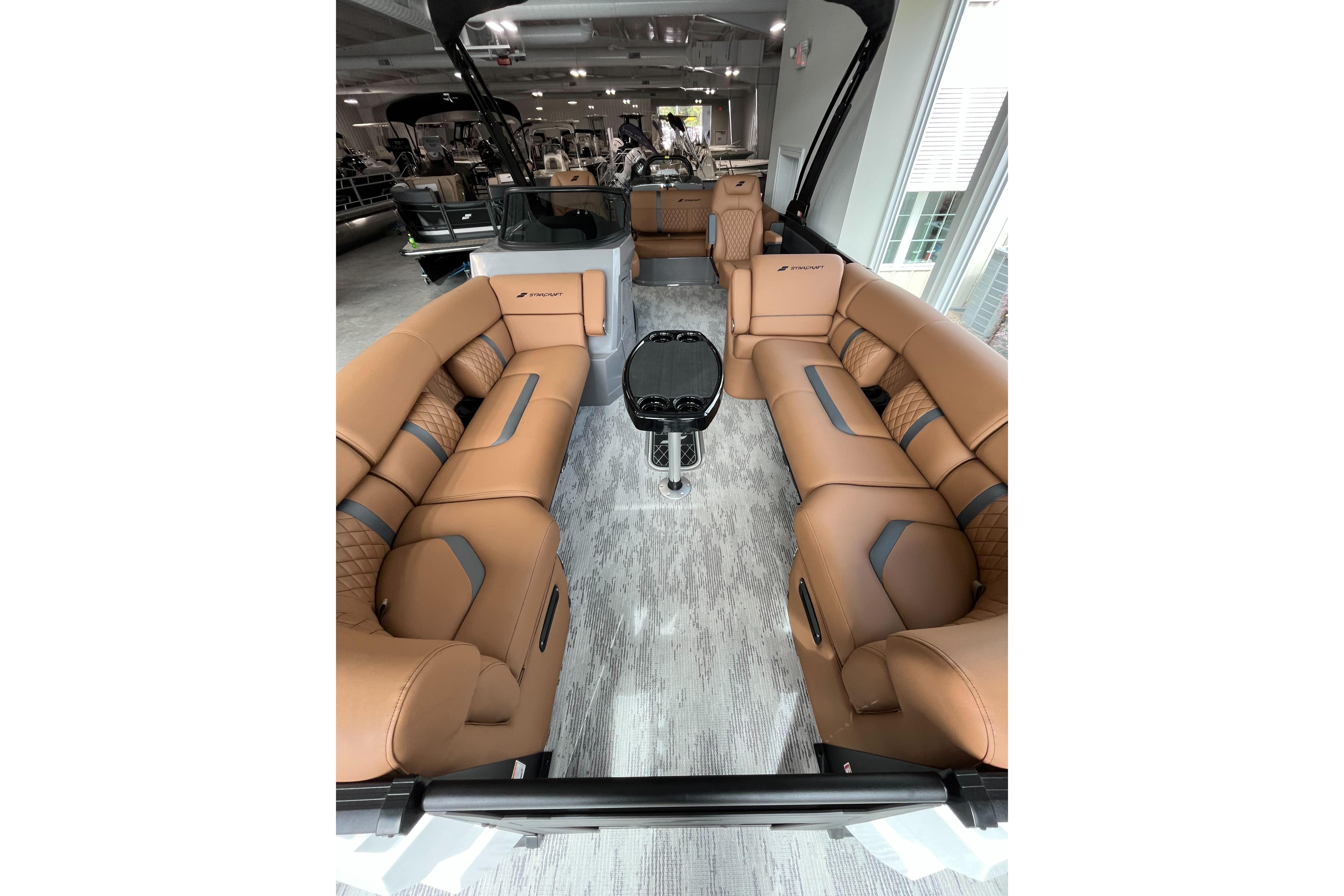Luxurious interior of 2026 Starcraft RX 25 DL DC boat with tan seating.