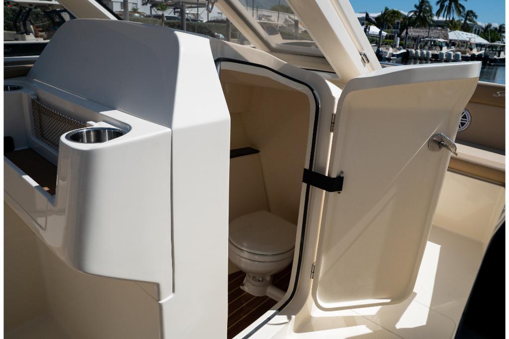2023 Scout 240 Dorado boat interior with open cabin door and visible toilet.