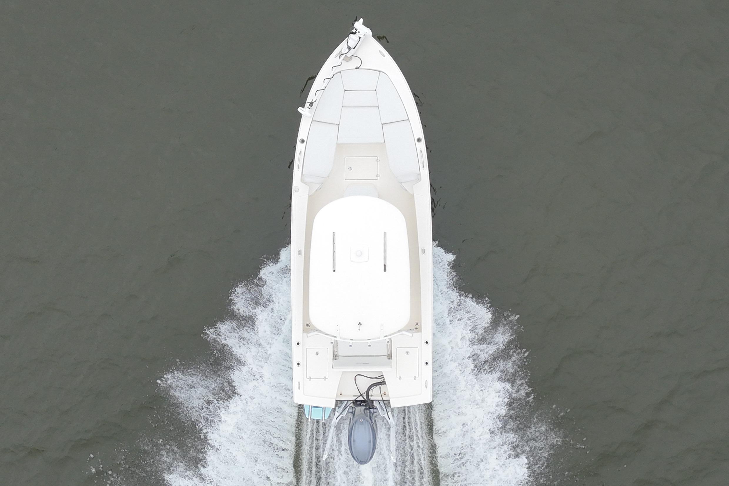 Aerial view of 2025 Pathfinder 2200 TRS boat cruising on water.