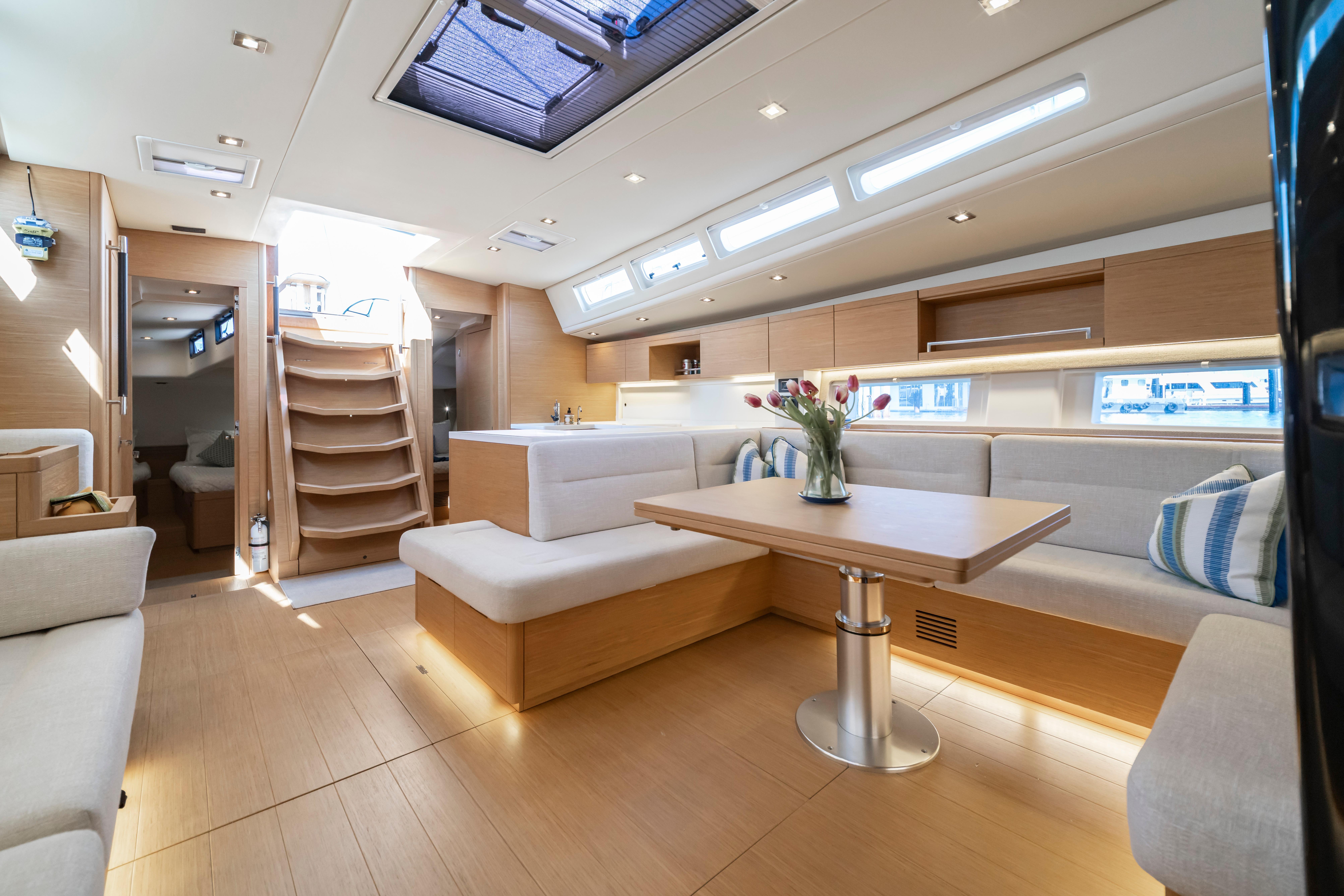 Luxurious interior of 2016 Grand Soleil 58 yacht with modern seating and dining area.