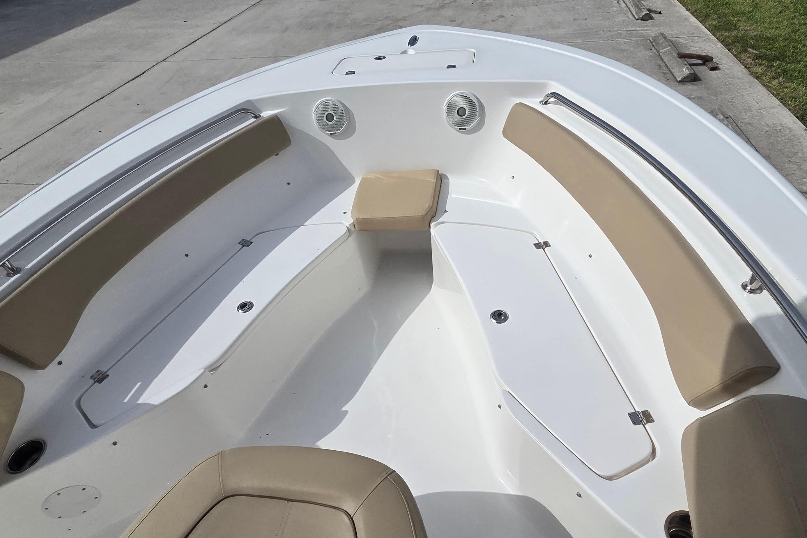 Bow seating area of a 2015 Tidewater 220 LXF boat with tan cushions.