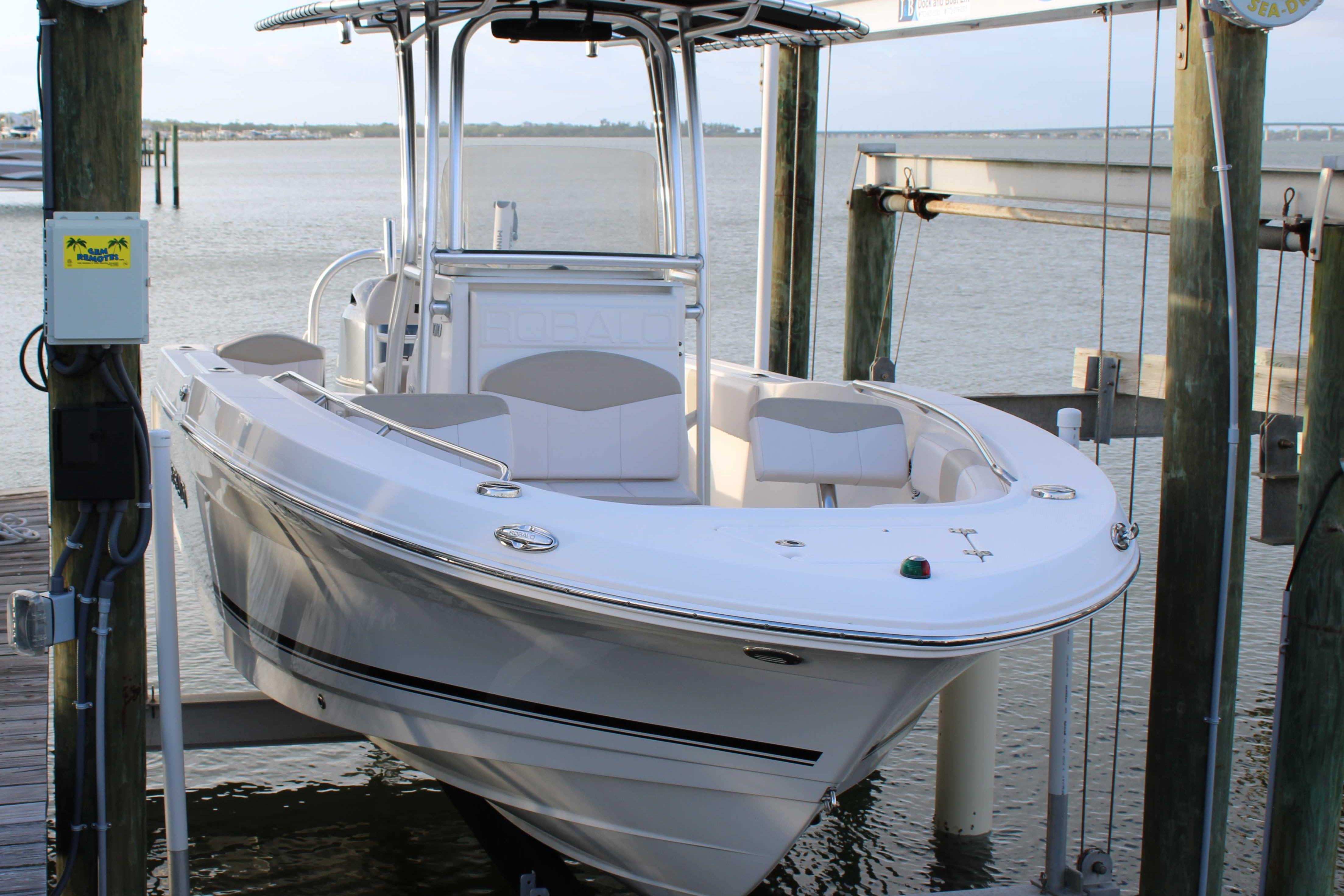 2017 Robalo R200 Center Console boat docked on a lift by the water.