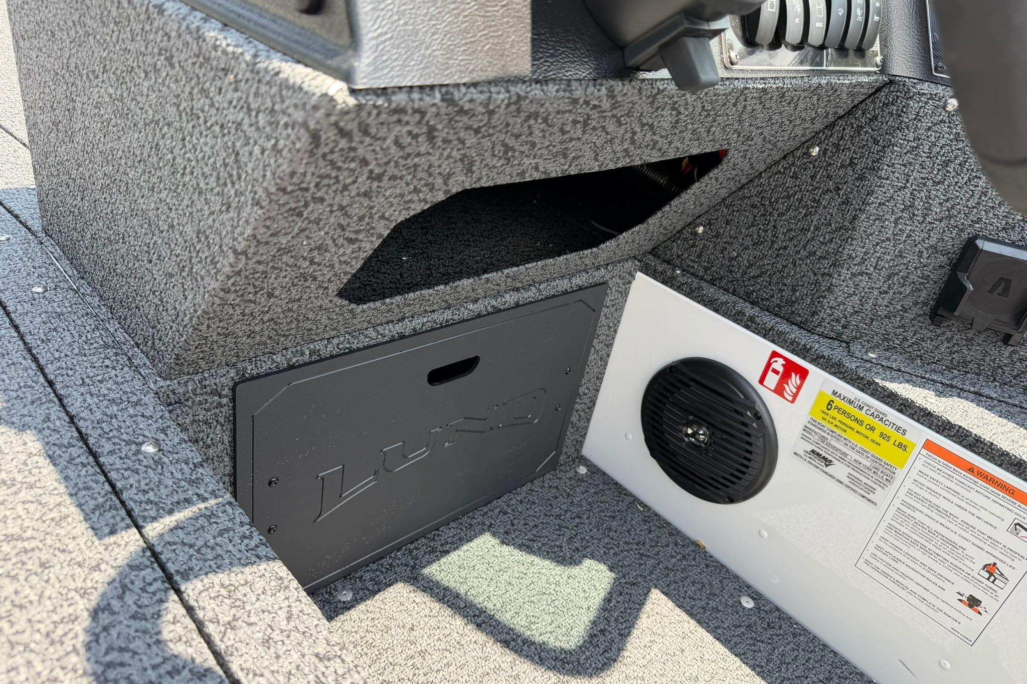Interior view of 2027 Lund 1675 Adventure Sport boat, featuring storage and speaker.