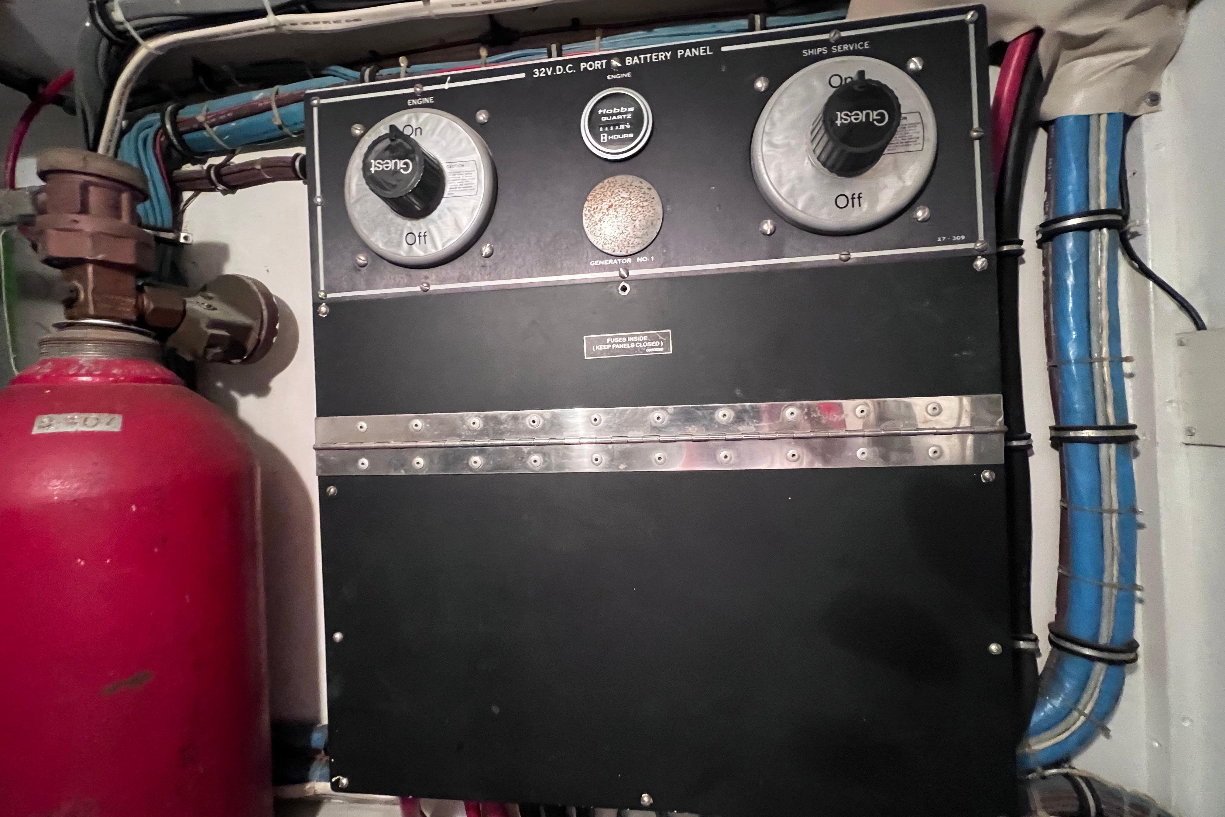 Electrical panel on a 1987 Hatteras 70 Cockpit Motor Yacht, featuring switches and wiring.