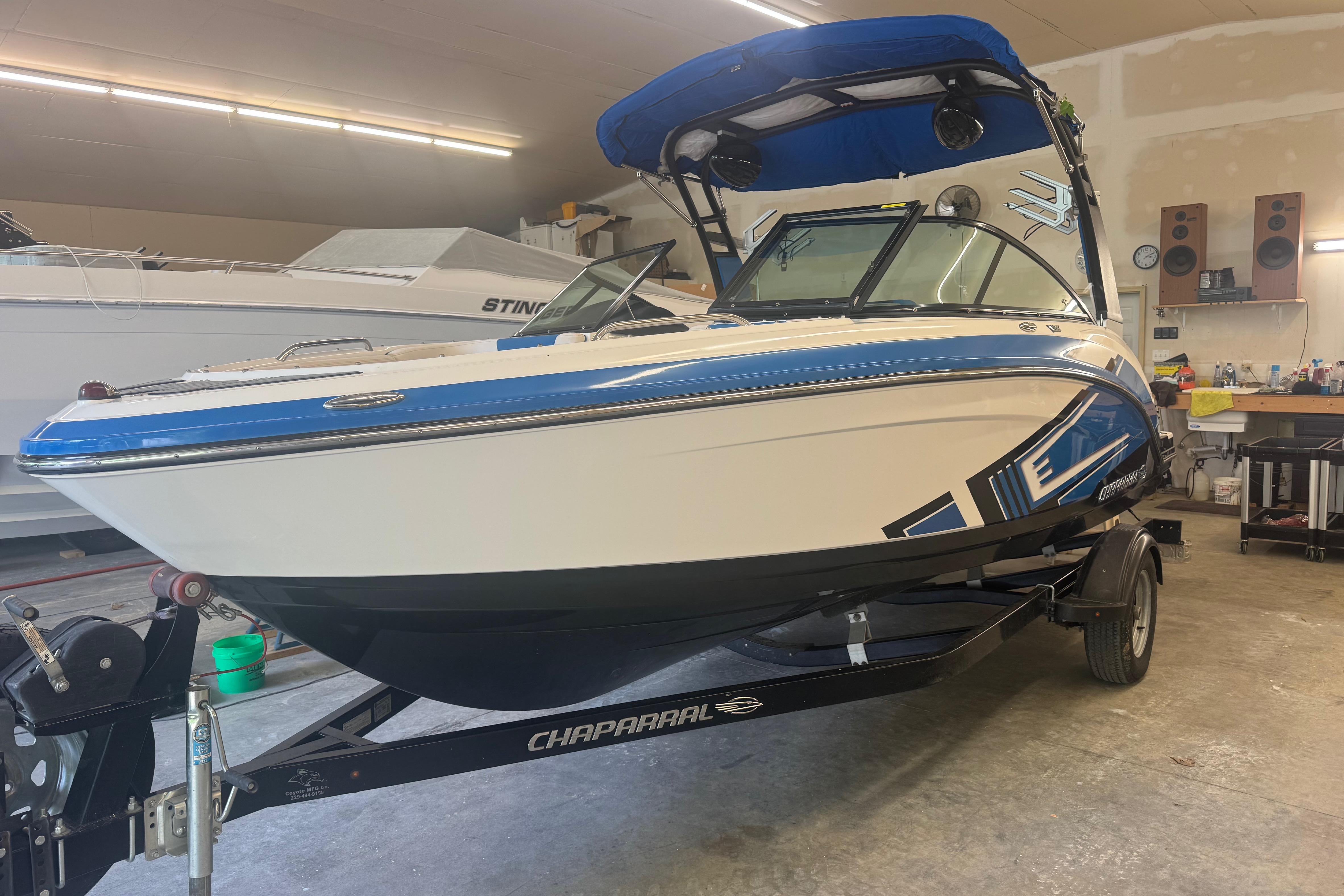 2017 Chaparral Vortex 203 VRX boat in garage, blue and white design.