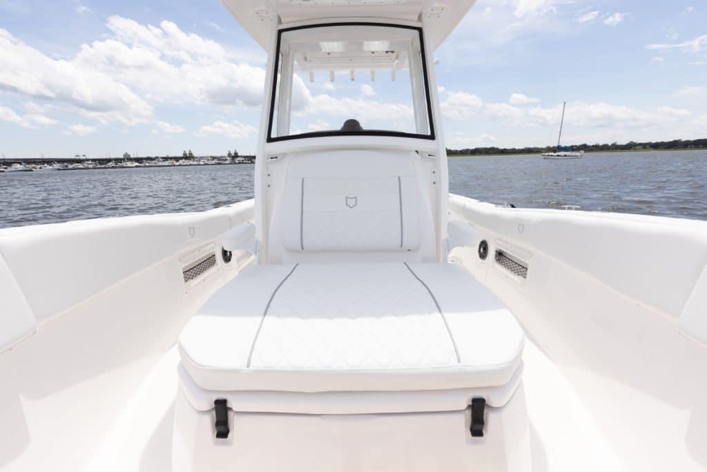 2027 Sea Fox 268 Commander boat interior with white seating, on a sunny day by the water.