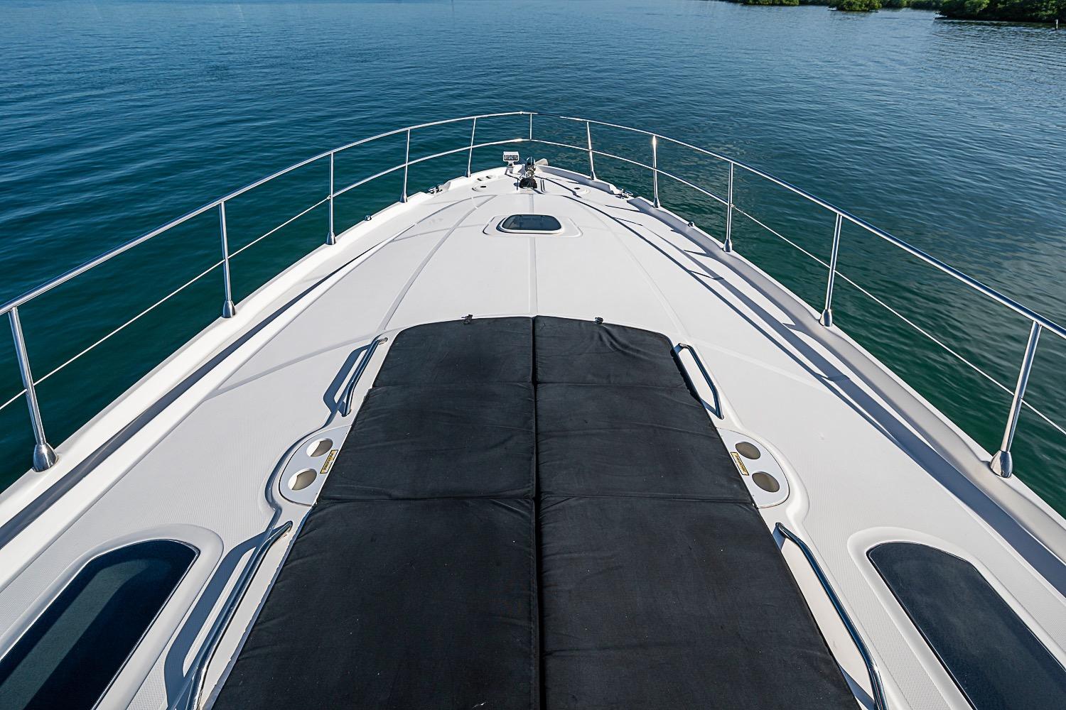 Bow view of 2008 Sea Ray 60 Sundancer yacht on calm water.