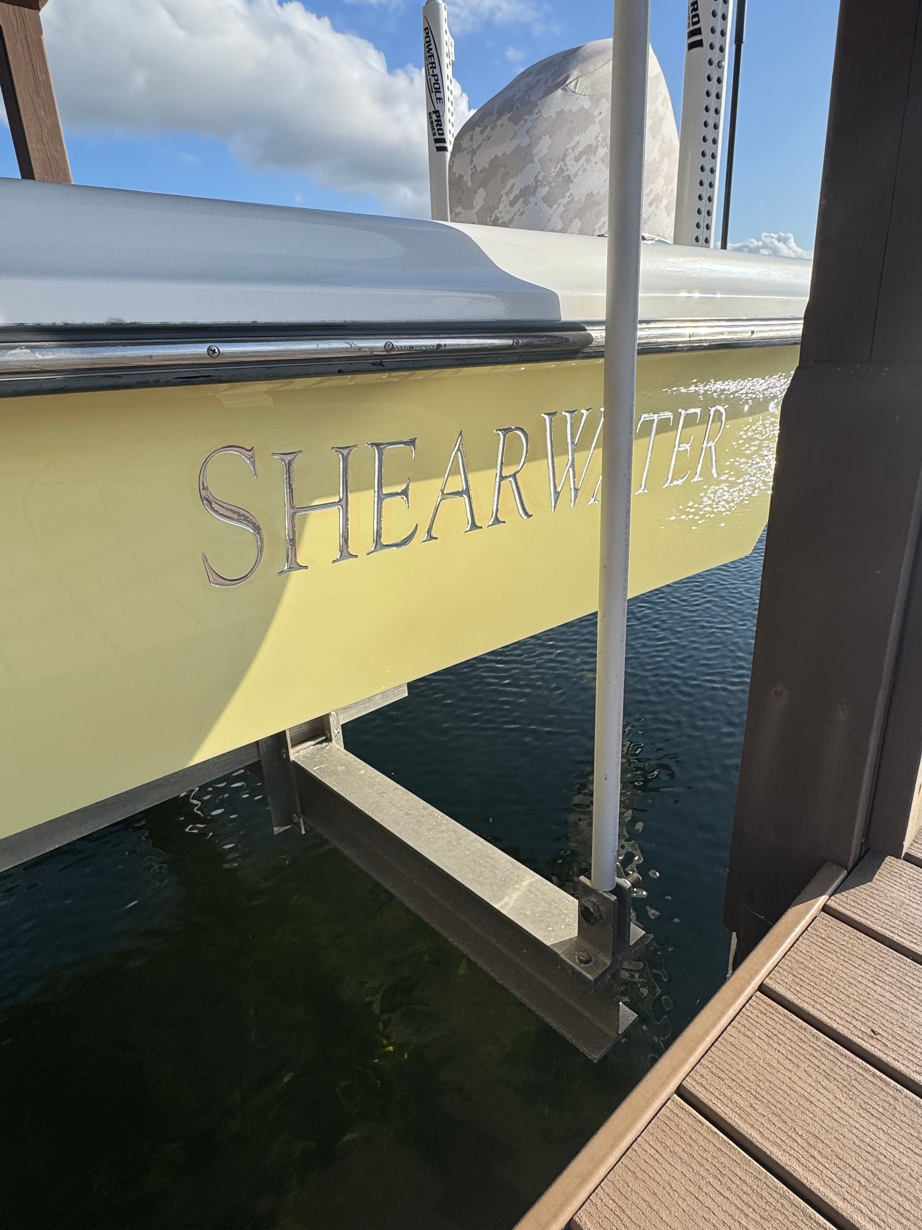 2004 ShearWater LTZ boat at dock, yellow hull.