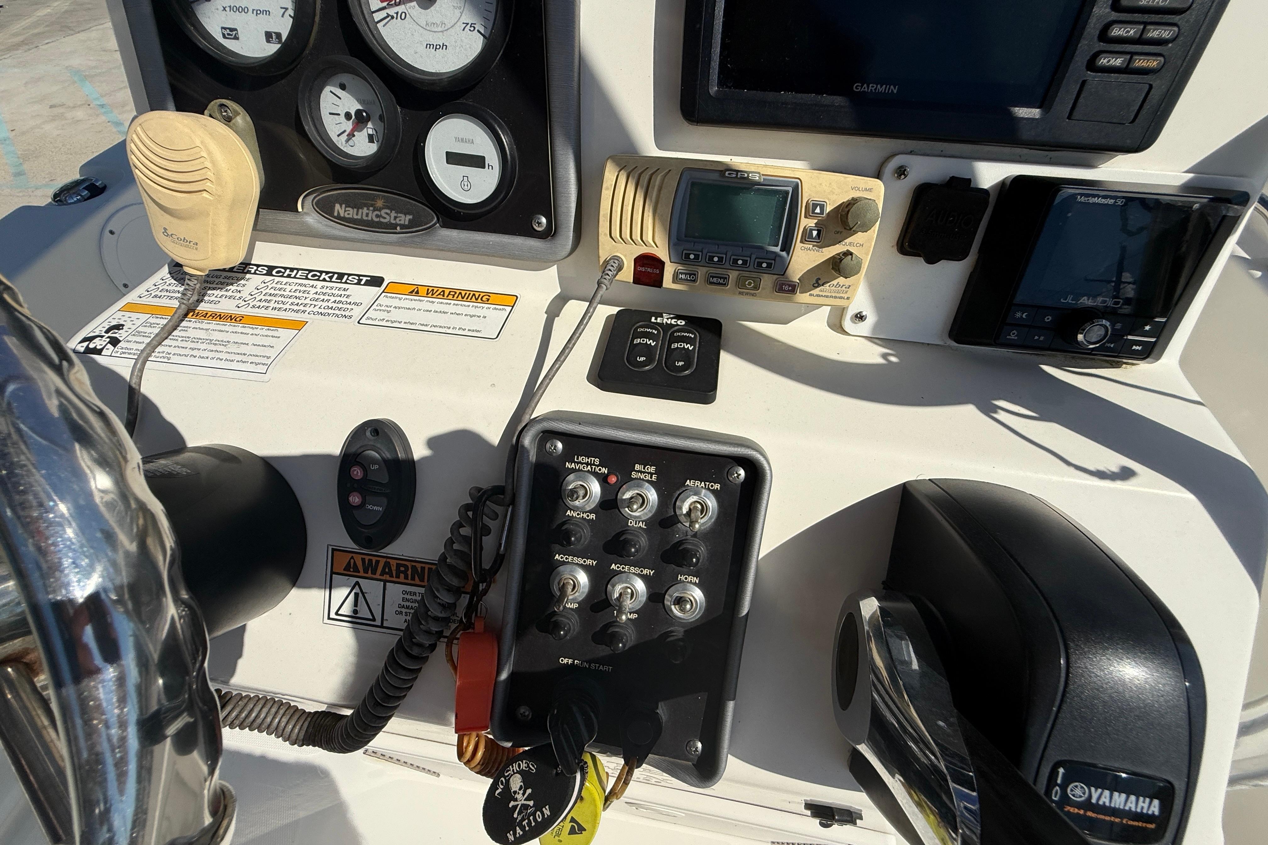 2019 NauticStar 19 XS boat dashboard with controls, gauges, and Yamaha throttle.