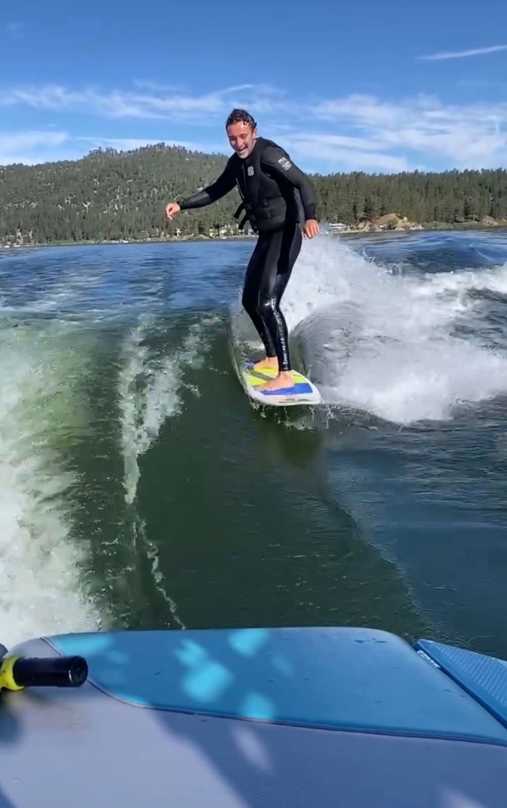 Person surfing behind a 2021 MasterCraft NXT22 boat.