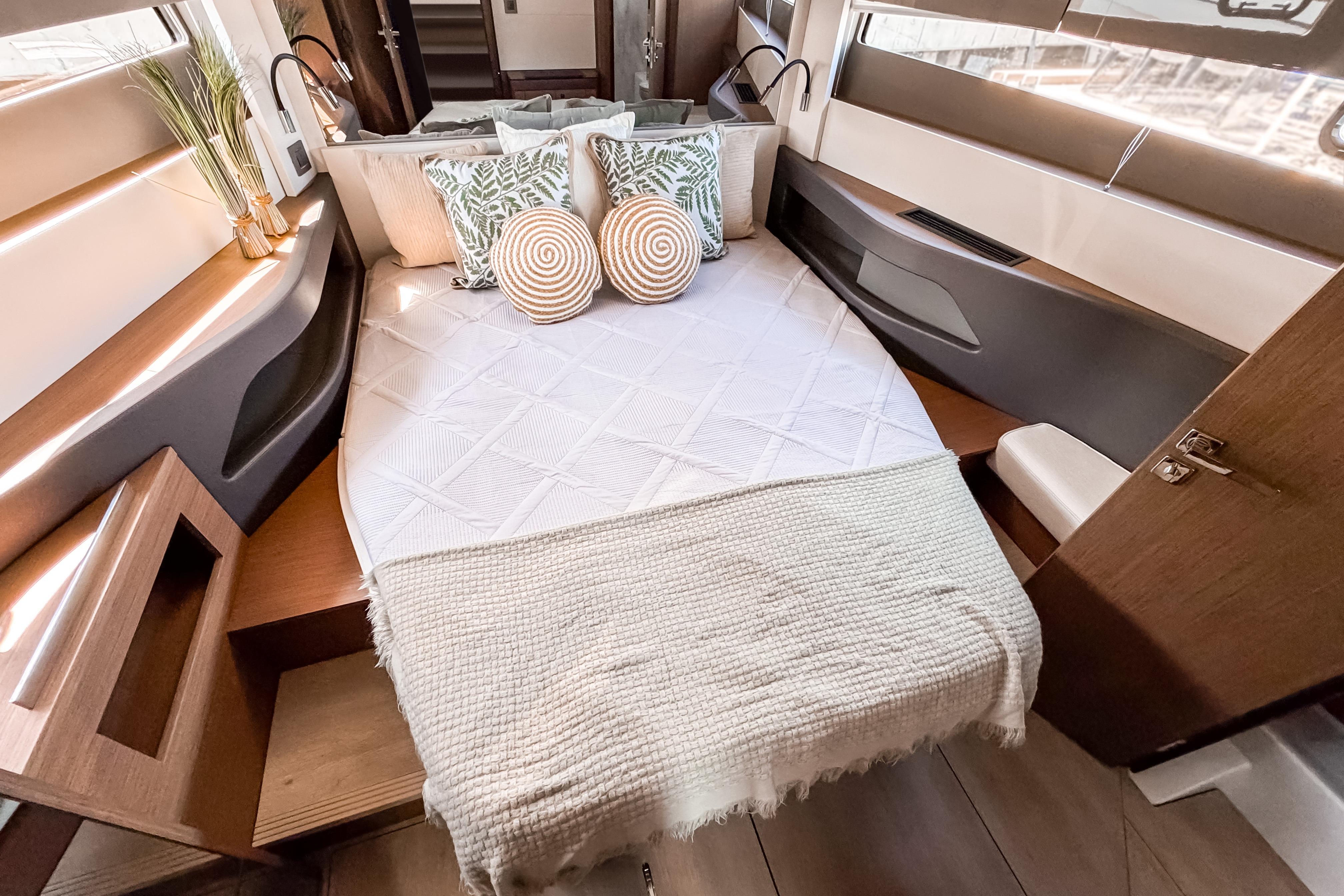 Interior of 2026 Wellcraft 44 Explorer featuring cozy bed and stylish design.