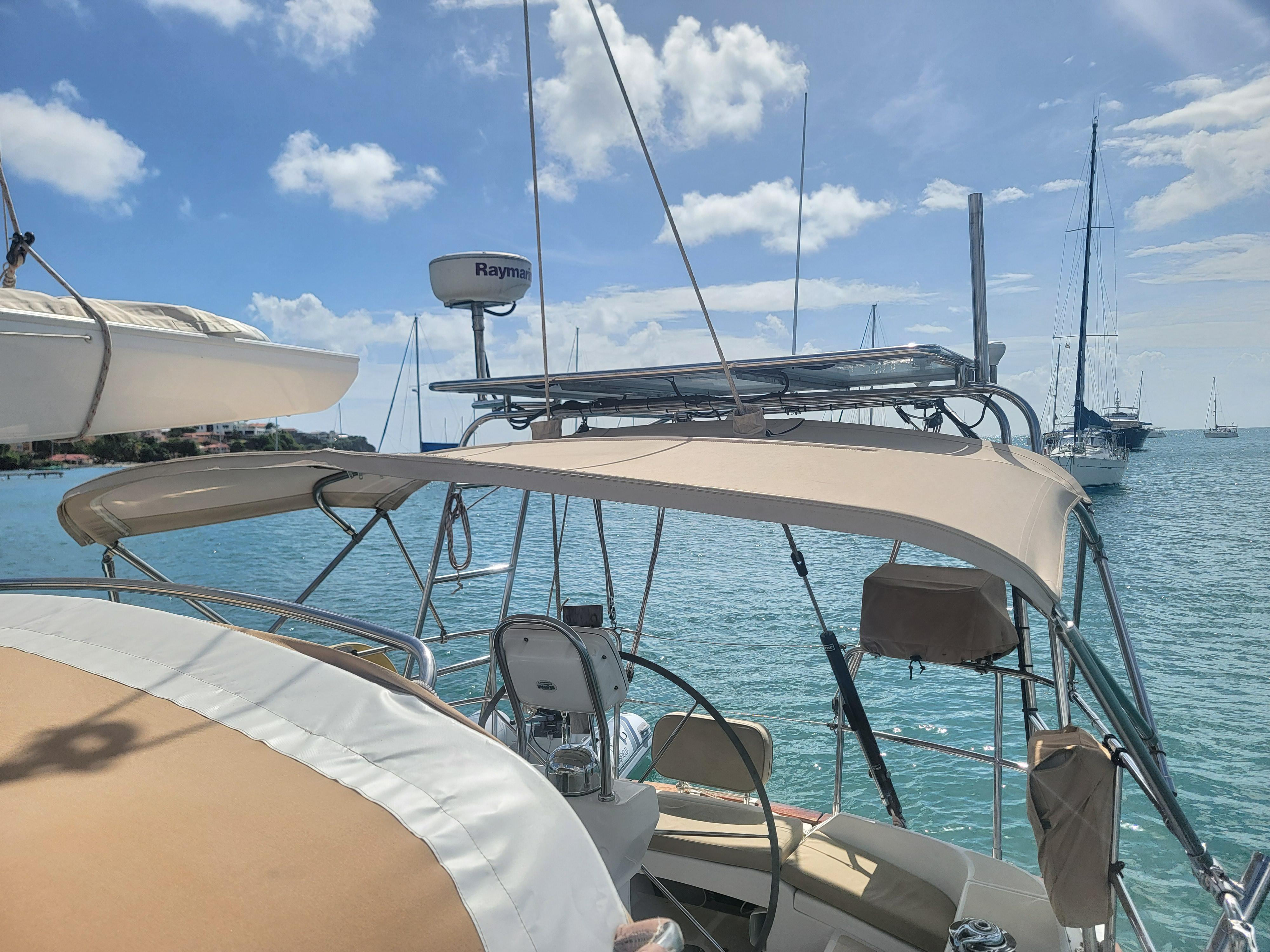 Sailboat Tartan 4300, 2008 model, docked in sunny marina with clear blue skies.