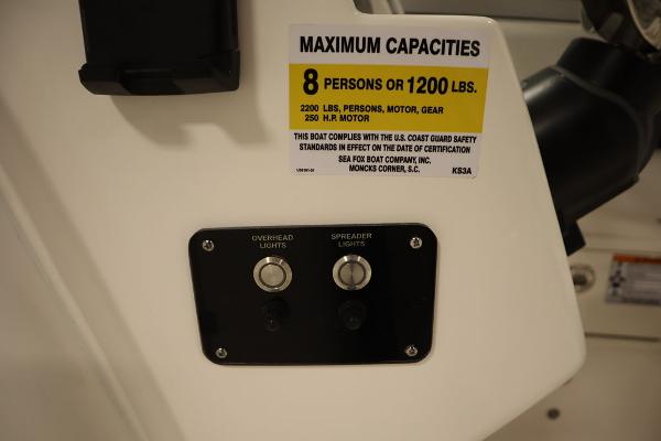 Sea Fox 228 Traveler 2025 boat capacity label and light switches.