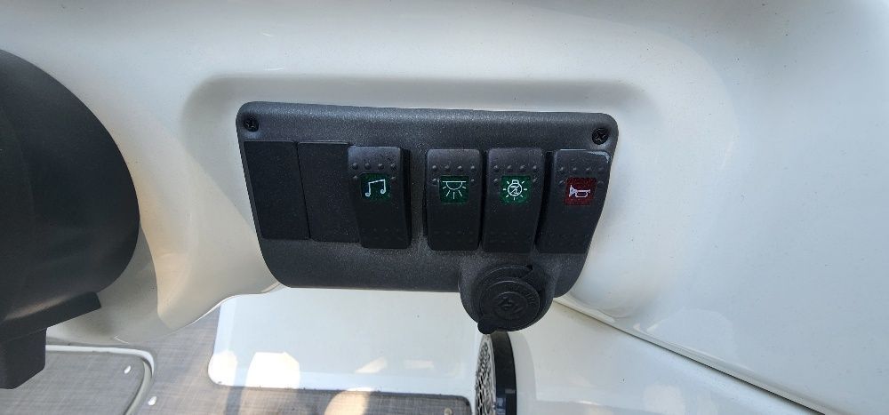 Switch panel with icons for music, light, anchor, and horn.