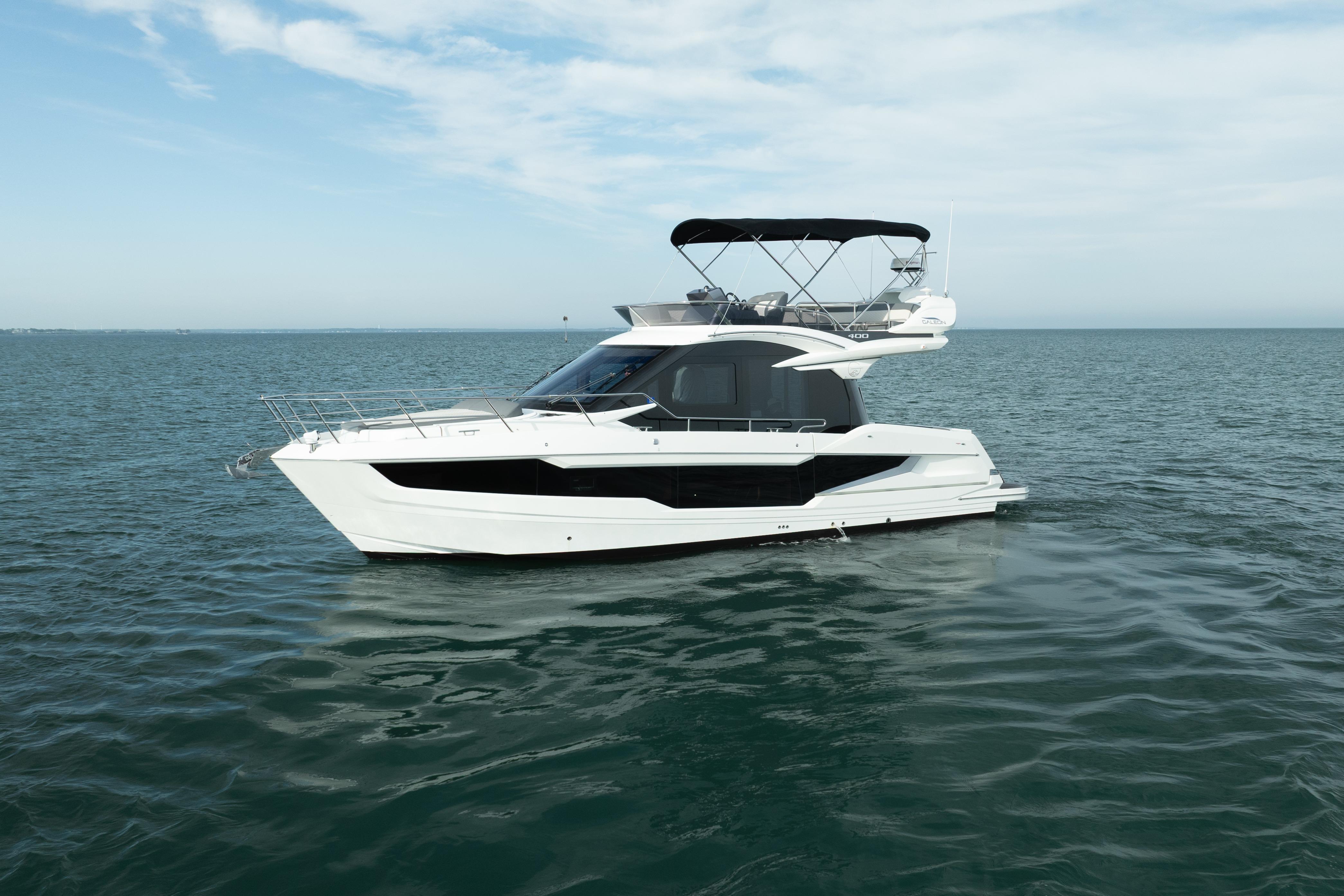 2023 Galeon 400 Fly yacht on calm ocean waters under a clear sky.