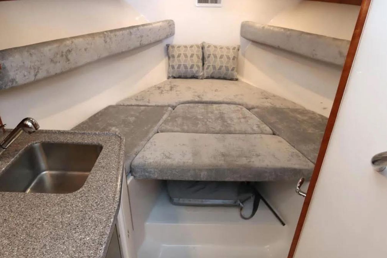 Interior of the 2024 Albemarle 30 Express with gray upholstery and a small sink.