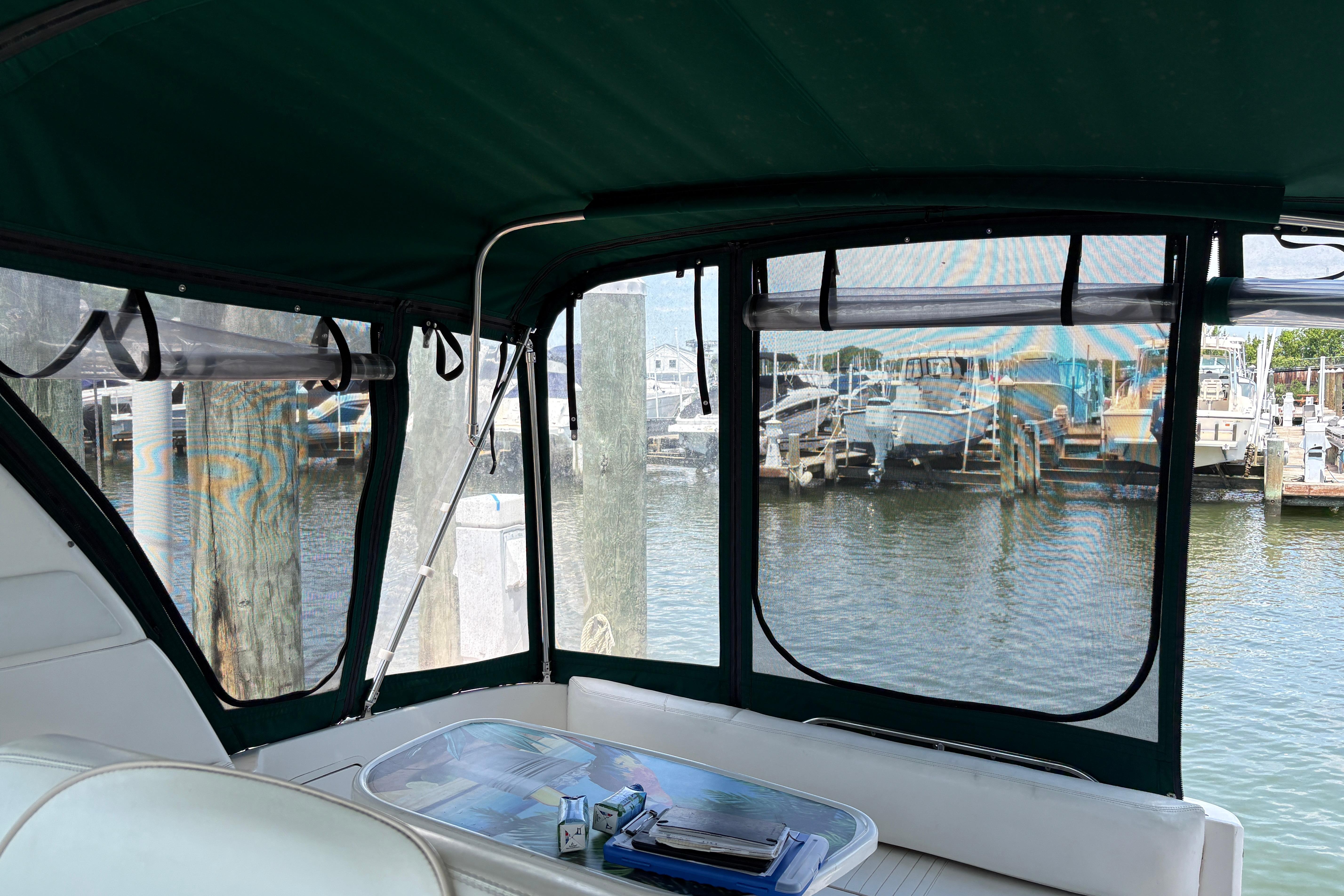Interior view of 2001 Sea Ray Sundancer 310 boat with marina backdrop.