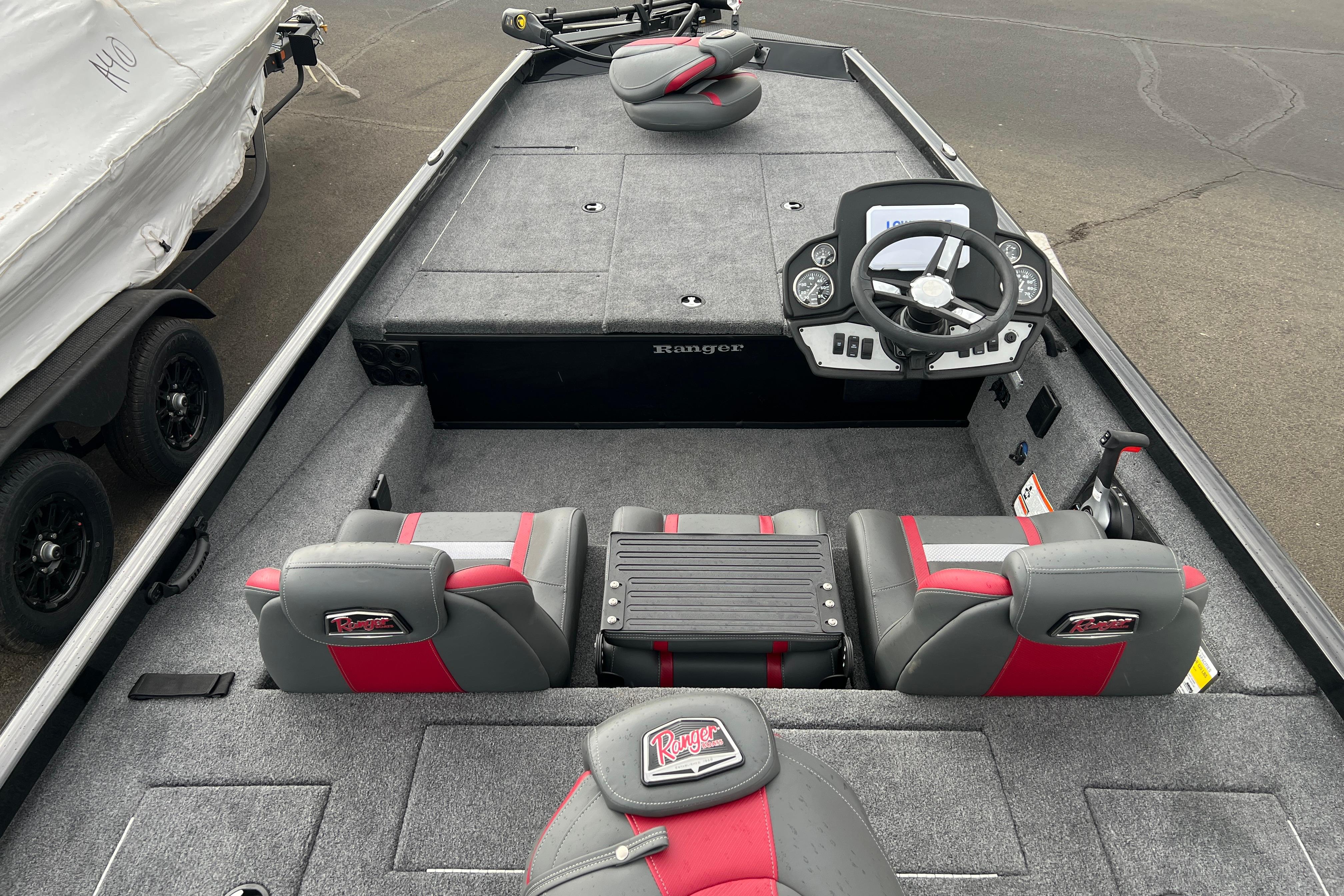 2026 Ranger RT188 boat interior with gray and red seating, steering console, and carpeted deck.
