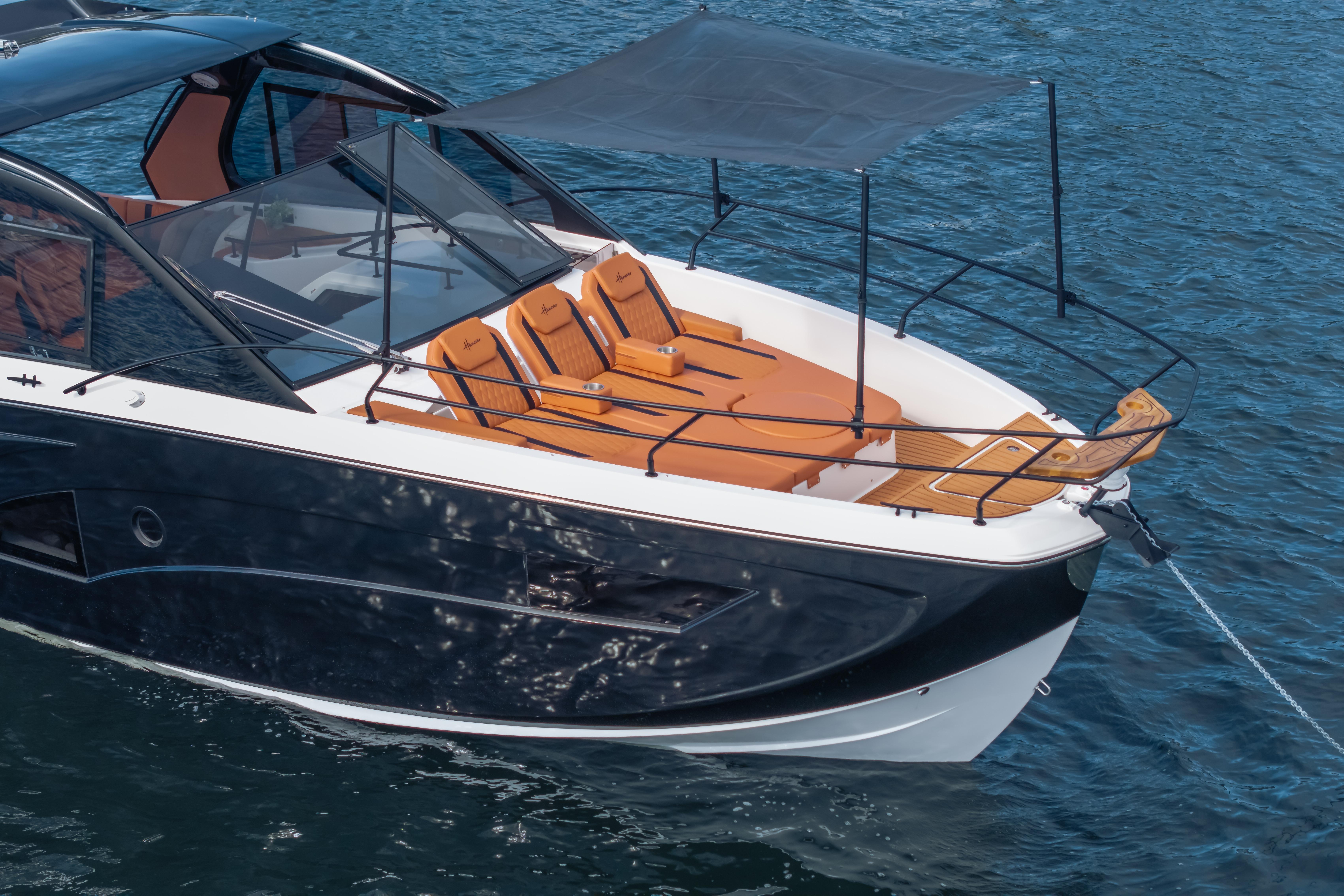 Luxury Hanover 387 yacht, 2026 model, with sleek design and sunbathing deck on water.